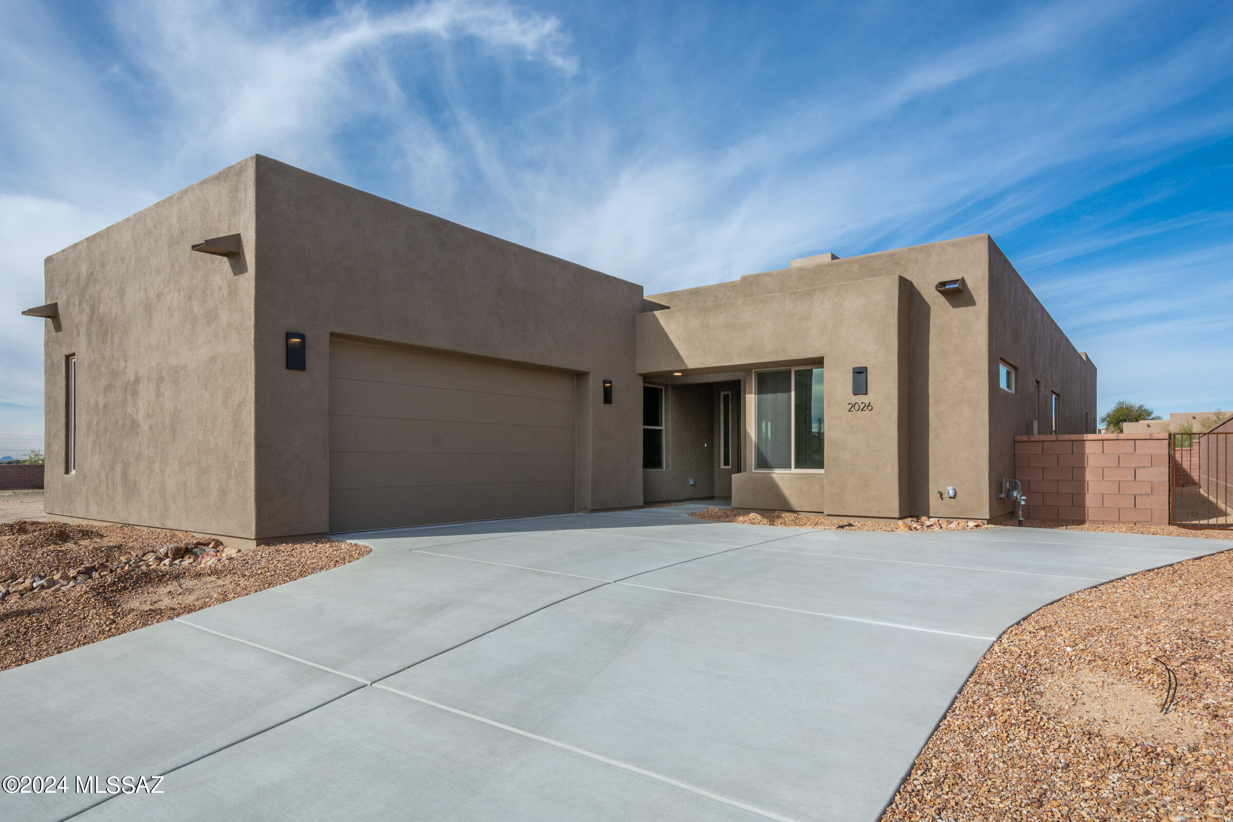 Come be a part of this absolutely stunning brand new gated community with luxurious homes designed by renowned architect, Ron Robinette and boasting a spectacular location just north of Magee and La Cholla.  Features in this gorgeous contemporary home include fabulous greatroom with very cool floating drop ceiling, lovely tiled fireplace, huge gourmet island kitchen, stainless steel appliances, granite counters, tons of cabinetry and designer tile floors.   Other amenities include spacious Primary Suite with generous walk-in closet, dual sinks and beautifully tiled walk in shower.  6-panel doors and beautiful lighting fixtures thruout.  Block walled in backyard w/exposed wood beam covered patio and beautiful mountain views.  2-car garage.