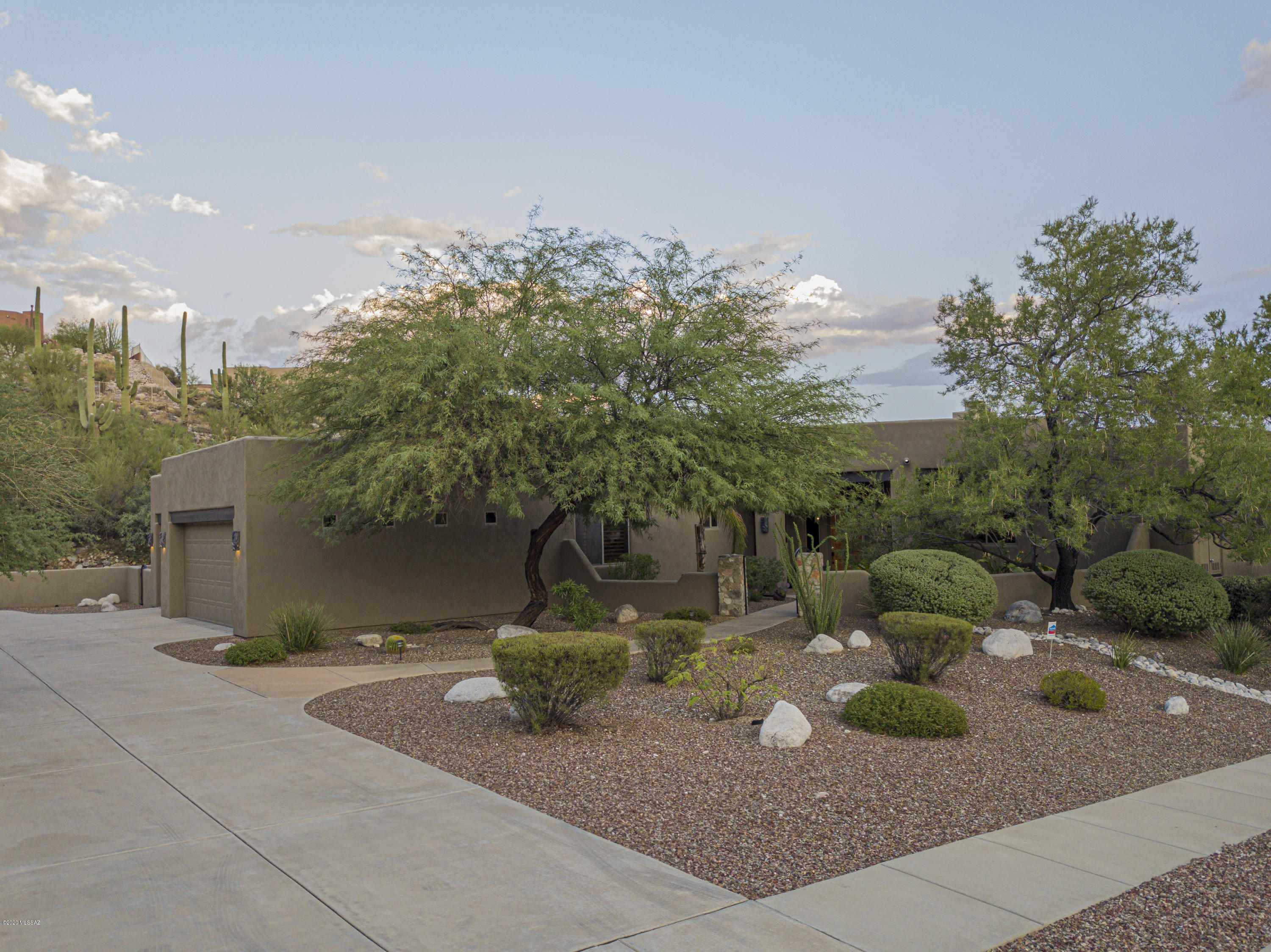 Nestled behind the prestigious gates of Sabino Mountain sits this stunning, beautifully-updated southwest contemporary home, which offers a large pool + spa and a plethora of luxurious upgrades. Beyond the private courtyard surrounded by mature trees and lush landscaping awaits a bright open floor plan with 12-foot ceilings, a newly-renovated expansive great room with beautiful floor-to-ceiling stacked stone, linear electric fireplace, custom cherry cabinets, floating shelves and built-in theater surround sound. The completely renovated gourmet kitchen boasts acres of Cambria quartz countertops, including a large island with breakfast bar, custom maple cabinets and black stainless appliances. You will love the completely updated master bath with large walk-in shower and... ...freestanding tub, and the refined upgrades throughout the rest of the house. (Please refer to the extensive list of recent improvements under our documents tab)

In addition to all of this, you'll enjoy the best of desert luxury living: Nice views of the natural desert, glimmering city views at night + Santa Rita mtn views during the day, built-in outdoor BBQ, beehive fireplace, mature trees, beautiful landscaping, pebble tec Pool, and spa w/waterfall. Not on the ridge but priced accordingly. Close to Sabino Canyon, Canyon Ranch, upscale restaurants, shopping, and more.
