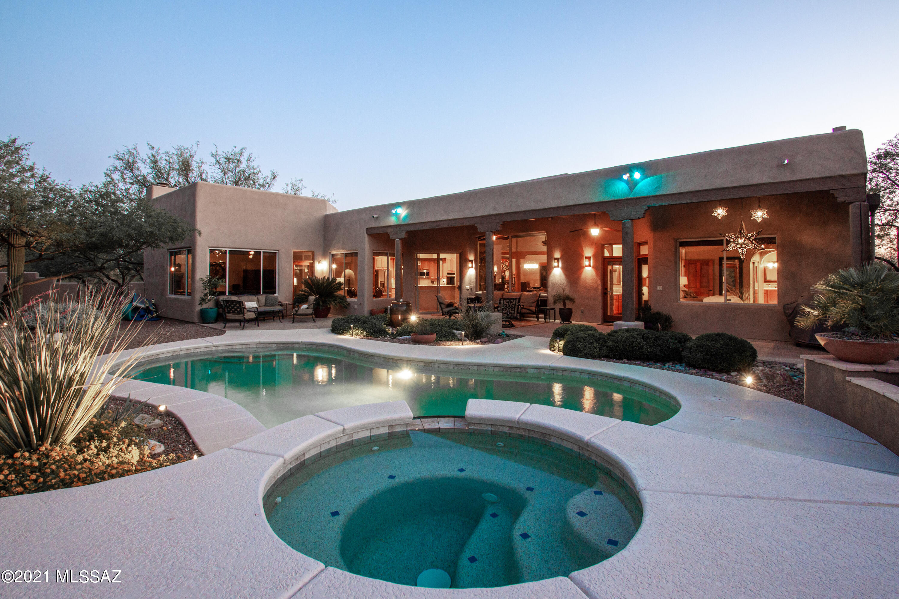 You will love this Immaculate home with fabulous Catalina Mountain views and outdoor living space.  Inviting courtyard with fountain greets you, enter through the custom wrought iron door.  Generously sized rooms with both formal & casual living spaces, desirable split bedroom floorplan. Wonderful Santa Fe style with high ceilings and wood beams, beehive fireplace. Gourmet kitchen with granite counters, large island, double ovens, pantry and gas cooktop.  Glorious natural light throughout with many skylights. Owner's suite with dual closets, fireplace, his'n'hers vanities, separate shower & jetted tub. Spectacular outdoor space with refreshing pool/spa, covered patio, fireplace, the perfect entertaining setting. Oversized 3 car garage with coated floor, built in cabinetry and plenty of storage space. The HVAC units, roof, water heaters all replaced 2017.  Water softener and whole house filter in place.  So many wonderful custom details here, you truly must see this one to appreciate.
