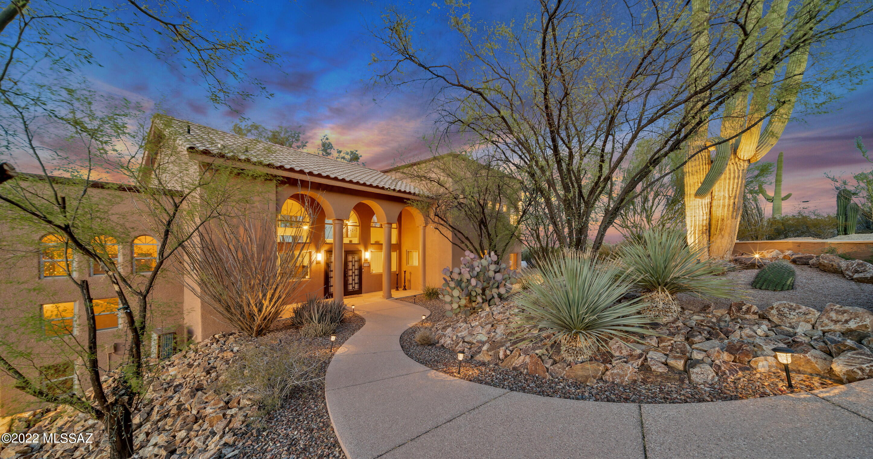 Set on an idyllic perched 3.72 acre lot, this 4191 sqft home is perfectly oriented to maximize the panoramic views! The expansive backyard flows seamlessly across the flagstone patios through the hardscaped yard to the sparkling pool and spa with unobstructed views of the surrounding mountains, lush desert and the lights of the Tucson valley. Enjoy multiple indoor and outdoor ''living'' areas – the formal living room, the family room, flex room (on its own level), multiple patios, the gazebo, and the enclosed pool area – just think of all the entertaining! The open kitchen, adjoining the family room and breakfast nook, features granite counters, stainless steel appliances, center island, sit-up bar, walk-in pantry and VIEWS every which way you look! The primary suite is a private retreat with its double doors that open to a large balcony where you can delight in your morning coffee, or catch-up on your emails or just watch the amazing, ever-changing mountain, desert and sunrise vistas from the over-sized windows. The en-suite bathroom features a double vanity with granite counter, a soaking tub, a spa-like shower, walk-in closet and views. Or enjoy the atmosphere and warmth of the fireplace dividing the bedroom and bathroom. The secondary bedrooms, located on the "main" level, also offer lovely views and share a hall bathroom with a spacious granite-countered double vanity and bathtub. The bedroom closets are roomy and have built-ins. Lower level is a "flex room"  currently used as a recreation area for movie watching and game playing (pool table conveys). For convenience, it has its own half bath.   All this privacy and desert living, but this resort experience is only minutes from I10, downtown Tucson, and UofA. The privacy and serenity will enchant you.  This beautiful residence is indoor/outdoor living at its finest!  Please see "Property Highlights" Document for further descriptions.