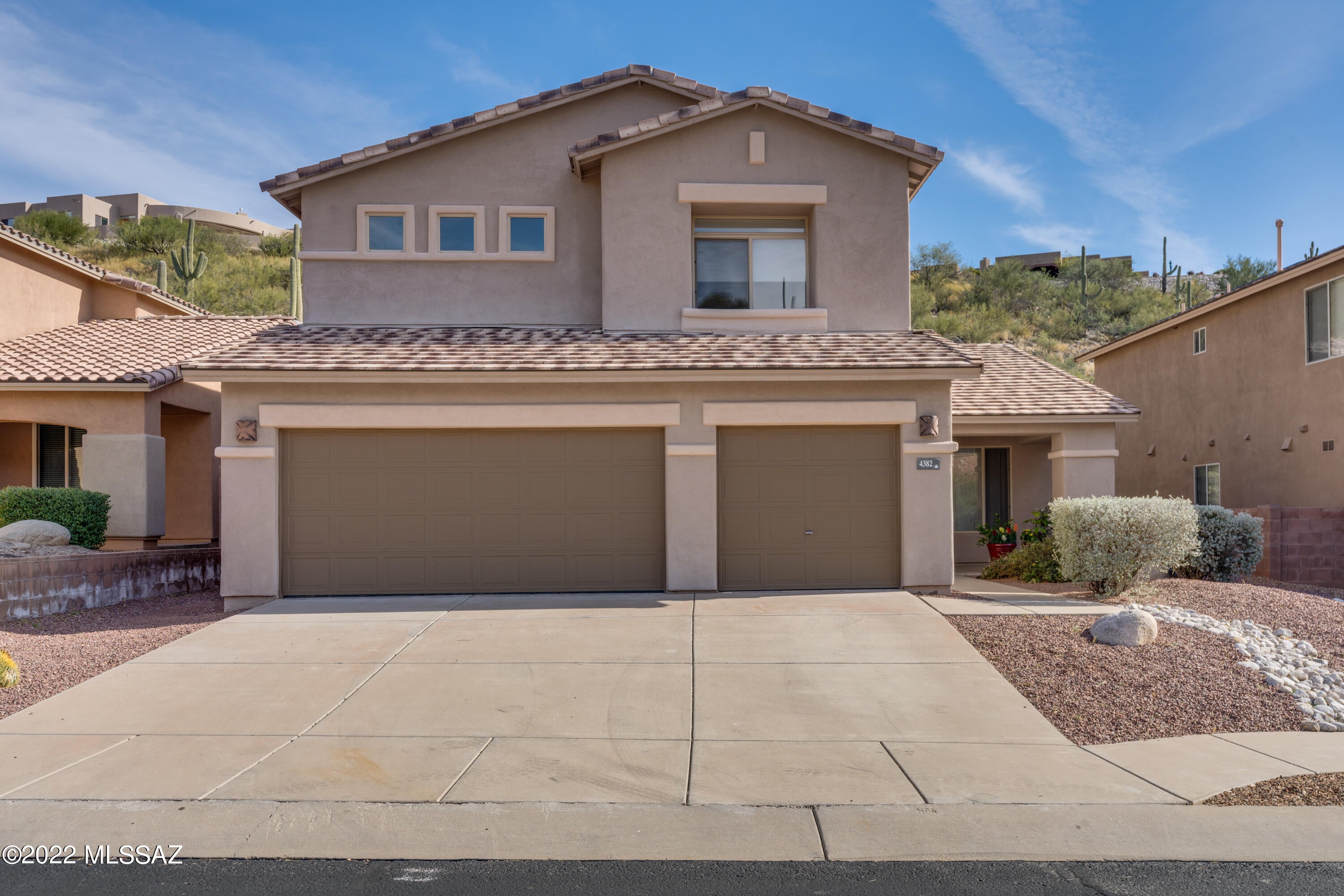 Gate community of Sabino Mountain. Upgraded 5 bed, 3 bath, 3 car garage home! Walk into an open floor plan with large energy efficient windows. Bed and full bath on first floor. Eat-in kitchen with ample cabinet & counter space, island, quartz counters, pantry and views of the fireplace. Expansive master bedroom with large en suite, walk-in closet & garden tub. Recent updates include epoxy garage floor, newly painted interior, Hickory flooring, ceramic tile in upstairs bathrooms, new hot water heater & water softener. Backyard includes beautifully lit patio where you can enjoy the mountain views and privacy. Easy to maintain landscape in the front and back yards with an updated irrigation system. Enjoy the community clubhouse amenities and pool. 1& 2-year lease options available.