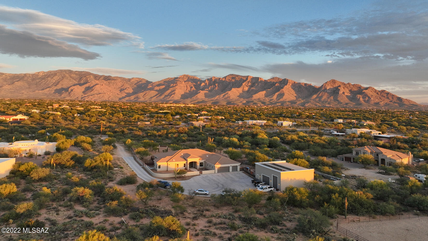Captivating panoramic mountain views from this spectacular home in Oro Valley. The home offers a total of 4,023 sq. ft. of living space and a spacious oversized 3 car attached garage. An additional detached garage has room for 4 cars and an RV, also features workshop area and a loft that can be used as a game room or gym.  This remarkable property is situated on 3.81 acres. Features include a 9-seat two-level home theater with state of the art system and 160'' Curved Screen. The open floor plan offers a great room with large glass slider that blends indoor and outdoor living. Capture the entirety of the Catalina Mountains, sunrises, sunsets, & city lights. Rear yard provides a dramatic setting to take in the views & natural life. See attached Feature List