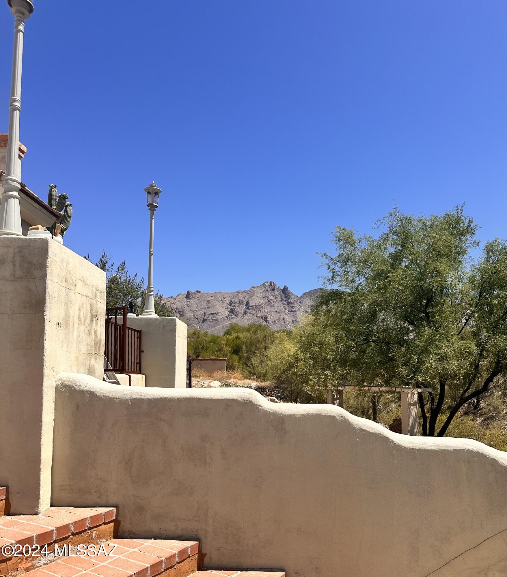 Offered AS IS. Nestled in the Serene Catalina Foothills, this exquisite property, needs some TLC back to luxurious living. Meticulously remodeled but needs a refresh, Grand entrance, breathtaking views, accentuated by the majestic presence of mature Saguaro's and private patios. Unconstrained by HOA restrictions, this gem features three bedrooms, each with its own en suite, with gorgeous closets and an additional room with a built-in Murphy bed and closet. The heart of the home lies in its gourmet kitchen, seamlessly blending style and functionality, while an outdoor kitchen enhances the allure of alfresco dining. Pool and spa beckon for leisurely afternoons under the Arizona sun and stargazing at night. Gorgeous Travertine floor through out, rolling shutters and more! ESTATE SALE June 7 and 8. To go live once all remaining items removed after Sale and pictures taken. Call to meet for private tour.
