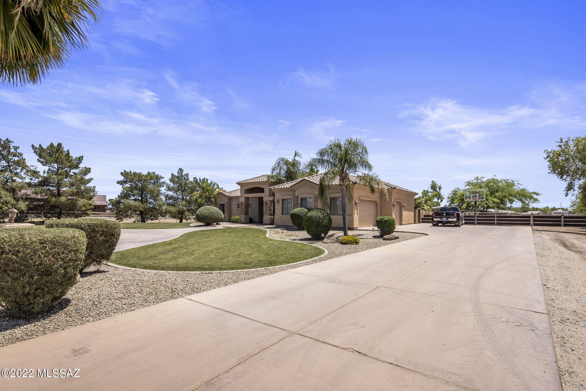 A rare find in one of the most desired horse property communities around. This stunning estate is on 5.77 acres w/ flood irrigation. The custom built 6 stall show barn includes auto waters, feeders, tack room & grain/ storage room. The facilities are designed perfectly w/ 7 additional stalls, 6 turnouts, 150x200 roping arena, cattle pen, an Equicizer hot walker, hay barn, wash rack, plus 3 acres of pasture perfect for livestock grazing or farming. Inside are many custom & newly remodeled features from the herringbone pattern tile flooring, to the 12' coffered ceilings. The kitchen features SS appliances, 42'' Hickory cabinets & granite countertops. The primary bedroom offers an ensuite w/ separate tub, floor-to-ceiling tiled shower & NEW quartz counters. See *Docs Tab* for a detailed list.