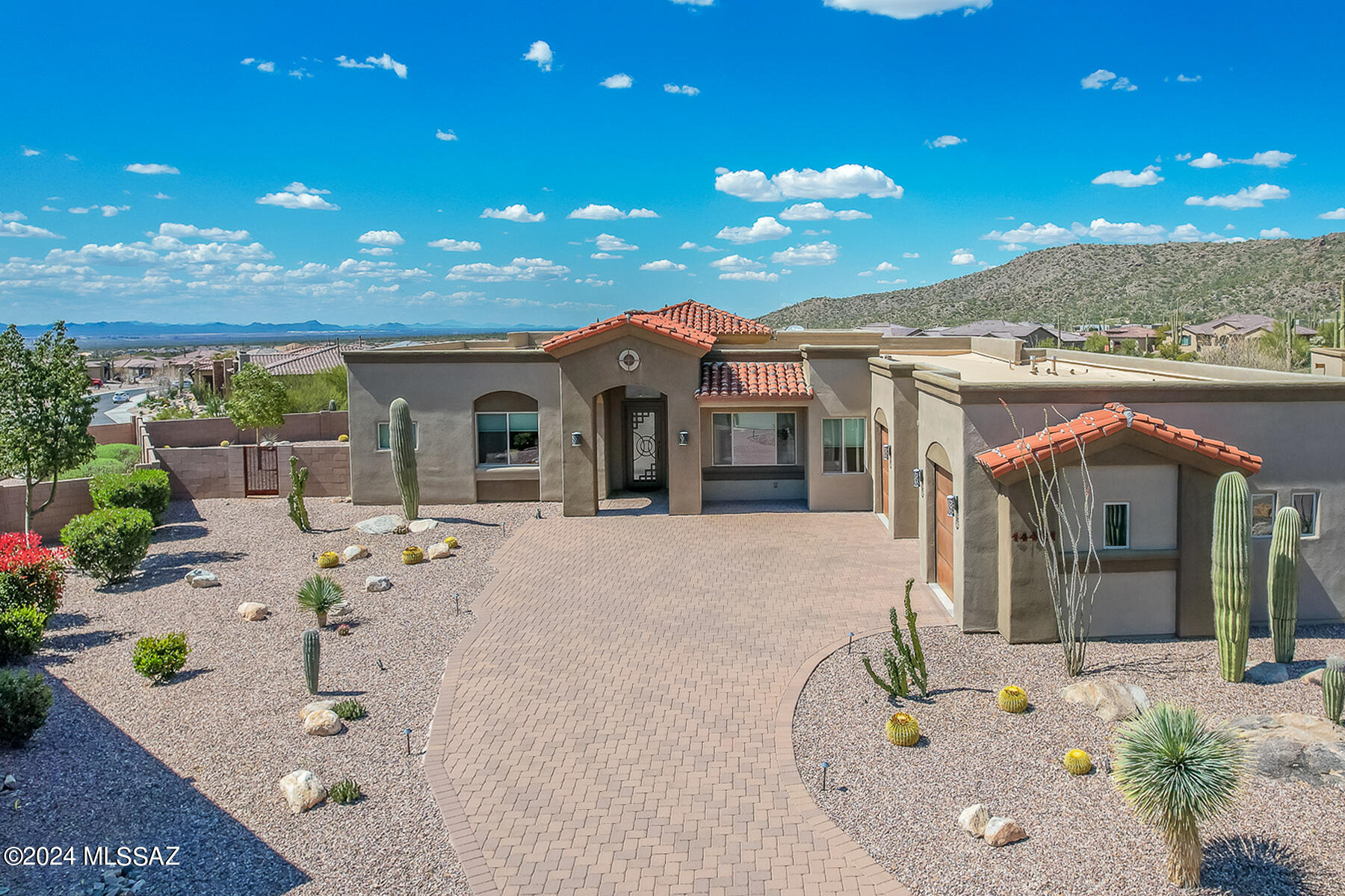 Spectacular former model on .38 acres in gated Boulder Bridge Pass at Dove Mountain boasts luxury details, resort-style living and forever views. Situated off the Saguaro nine at the Golf Club of Dove Mountain with a Tortolita Mountain backdrop, this 4BD/3.5BA (2,821 sq ft) Contemporary offers 3 ensuite bdrms plus 4th bdrm/office. Impressive gathering room showcases soaring ceilings, porcelain tile floors, custom media wall, formal dining and walls of windows accenting the views. Striking double island kitchen hosts Silestone counters/SS appls. Elegant Owner's suite affords a luxury spa bath. Brick paver drive off 3-car garage w/rustic iron doors. Expansive yard hosts covered patio w/pavers flowing to large, heated pool w/spa, outdoor FP & turf lawn. Perfect for the most discerning buyer!