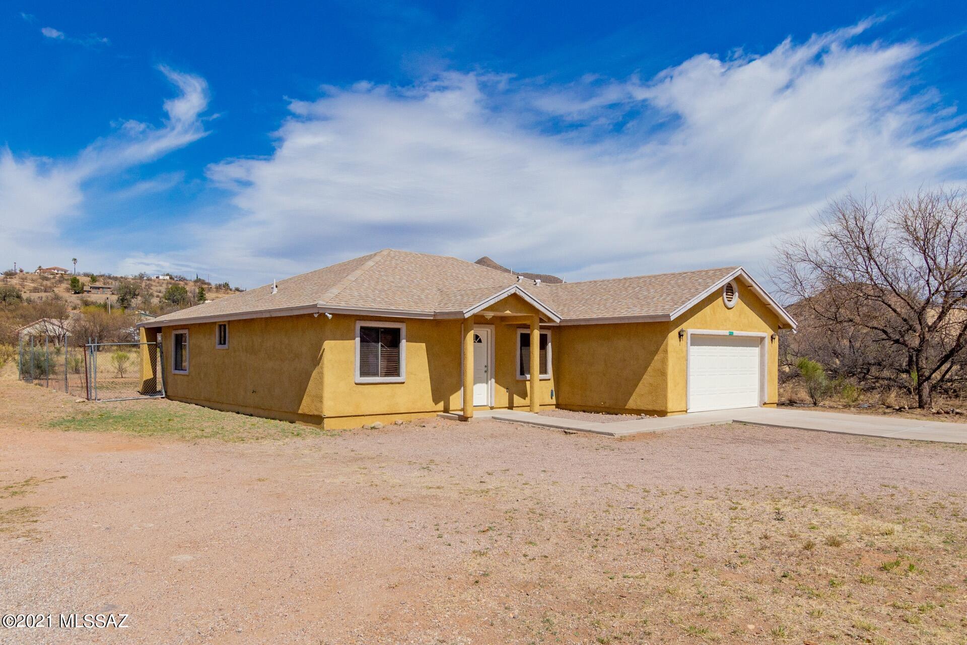 Beautiful home on just under a quarter of an acre! Surrounded by Mountain views! Dramatic vaulted ceilings, welcoming palette, handsome tile floors, ceiling fans, & open floor plan. Patio access from the dining area w/a chandelier. Stylish kitchen counters, breakfast bar, pantry, & plenty of wood cabinets. Easy home to make your own! Plush carpet in all bedrooms w/large closets, 2 pristine baths, window blinds, & an interior laundry room. The backyard offers a covered patio & is a blank canvas for your future desert oasis! Take a tour today & fall in love with this desert gem!