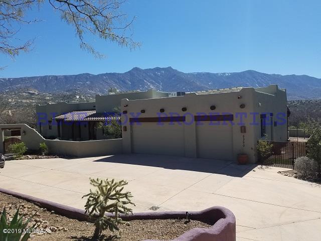 Tucked away in the perfect spot with nothing but peacefulness and quiet of the surrounding mountains. You will feel like you have been swept away to your own oasis, inside is just stunning. Walk in to the high ceilings, open living area with a cozy fireplace and a view into the amazing kitchen. The kitchen is an entertainers dream and you will fall in love with the unique cabinets and beautiful counter tops. Each of the bedrooms features its own private bath and the master bath feels spa-like. No matter where you are in this home, you will always have view of the sunsets and mountains. Summers outdoors will be a blast with barbecuing on your built in grill, relaxing under one of your two covered patios, and cooling off in the sparkling pool. Located a mile from Miraval Resort and Spa.