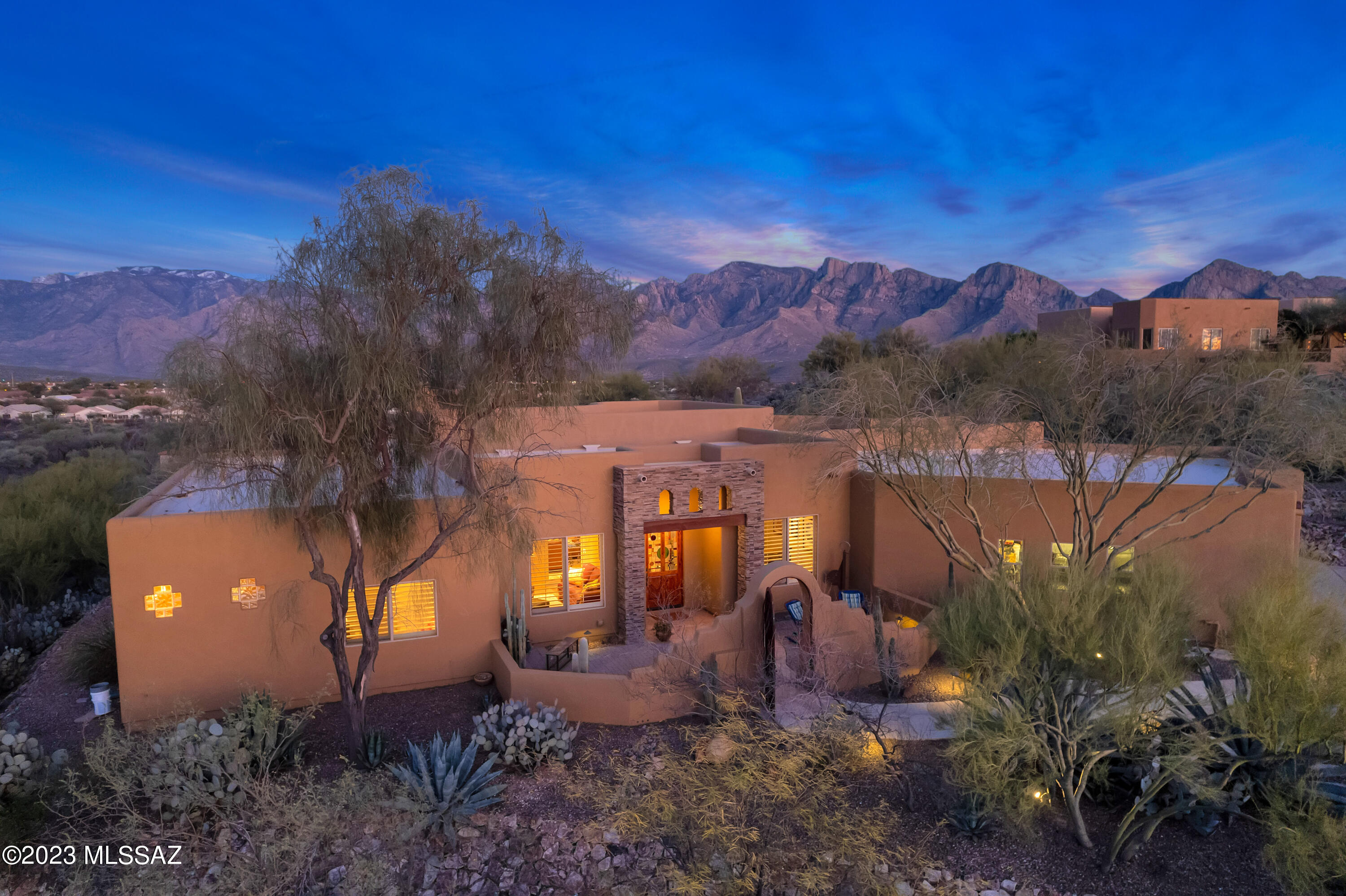 Welcome to your dream home in the heart of Oro Valley!  This stunning 4 bedroom, 3.5 bathroom residence sits on a spacious lot with breathtaking panoramic mountain views. The home is located in a highly desirable neighborhood, surrounded by natural beauty and offering easy access to world-class amenities.  As you step into the foyer, you'll be greeted by an open and airy floor plan that  blends the Great Room with the Dining area and kitchen.. The great room features a stacked stone  gas  fireplace, and large windows that let in plenty of natural light, with a seamless transition into the kitchen and dining area. The gourmet kitchen is a chef's chef's delight, with top-of-the-line stainless steel appliances, beautiful cabinetry, granite countertops , and a large center island.  The breakfast bar wraps itself around the sink counter top area and easily sits 6.  The dining area can accommodate a table set for 8..
The master suite is a true oasis, complete with a spa-like en-suite bathroom that boasts a soaking tub, separate shower with dual showerheads,  a double sink vanity, and a spacious walk-in closet.   Greet each day with a mountain view and from the bedroom, step out onto the patio for a morning soak 
 The split bedroom  floorplan features a 2nd primary suite  complete with a double vanity sink, spacious shower, and access to the patio area.   Great sized room to leave as a roomy  guest suite or  two siblings can share.  The other two guest bedrooms feature a Jack And Jill Bathroom with each side having their own toilet/sink and sharing the shower. .
The backyard is a true paradise, with a covered patio that's perfect for outdoor entertaining, an outdoor kitchen, a sparkling pool & spa, and stunning views of the mountains. You'll love spending your evenings watching the mountains change color at sunset  while  hosting barbecues and gatherings with family and friends.
Other features of this beautiful home include a spacious laundry room, a three-car garage with an additional storage room in the garage.  2 220 circuits have been installed to support an EV charging station.  This home is situated in a convenient location that puts you just minutes from shopping, dining, and entertainment. Don't miss your chance to make this incredible home yours  schedule a showing today!