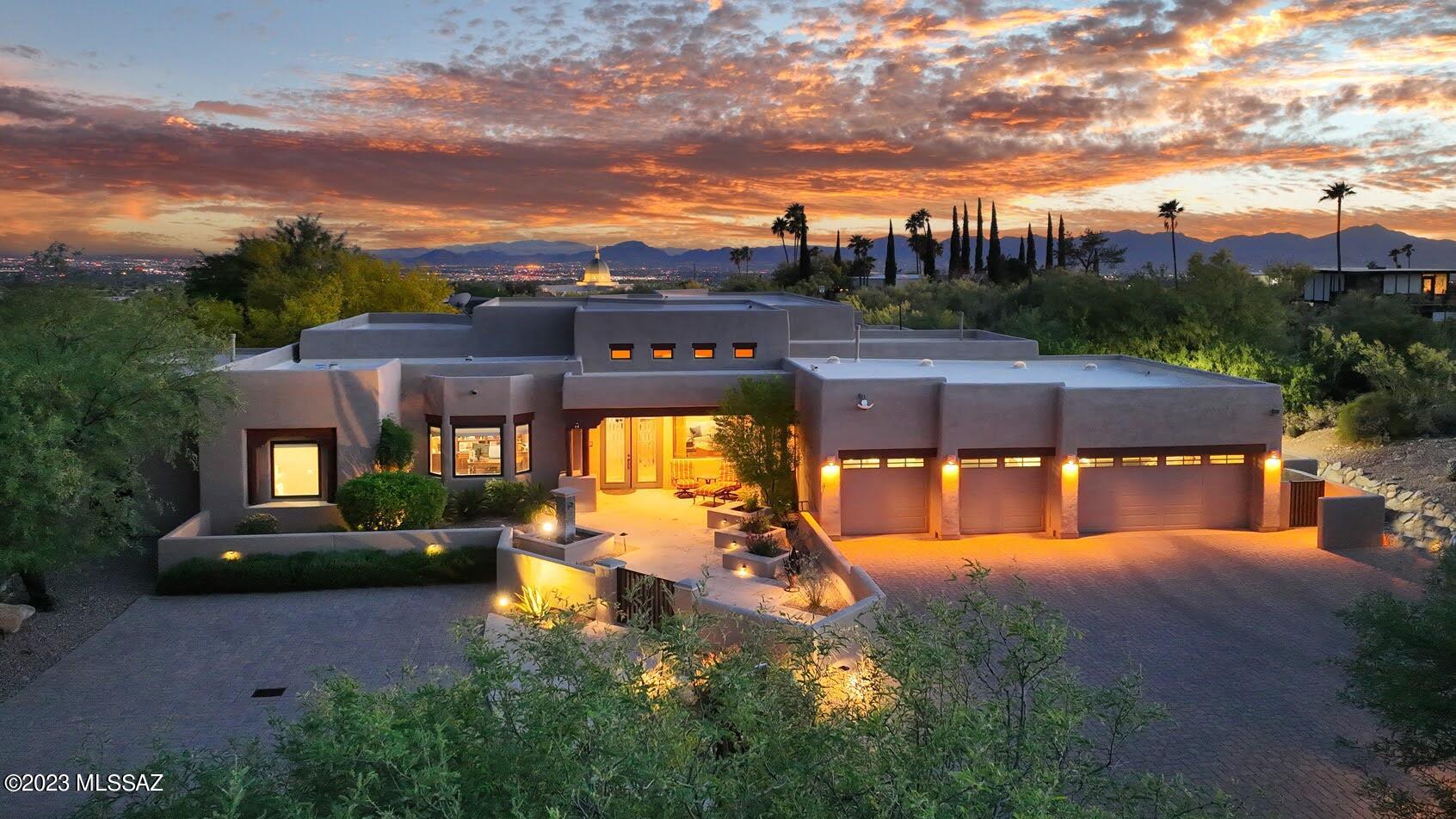 This gorgeous southwest contemporary home in Pima Canyon Estates is sure to please with quality attention to detail & hi-end finishes. Upon arrival, enjoy stunning mountain views as the charming courtyard w/fountain welcomes you into the elegant foyer, formal living & dining areas and beyond. Dream kitchen w/gas range, wall ovens, lg center island, rich cabinetry & gorgeous granite is open to the breakfast nook & greatroom w/fireplace & city views. The lush, peaceful backyard features a negative edge pool w/waterfall, spa, firepit, outdoor kitch & spacious covered patio, perfect for entertaining. Luxurious primary suite offers cove ceiling details, dual sinks, vanity, jetted tub, sep shower & incredible custom walk-in closet.  Gorgeous 5th bdrm w/blt-ins is currently being used as office.
