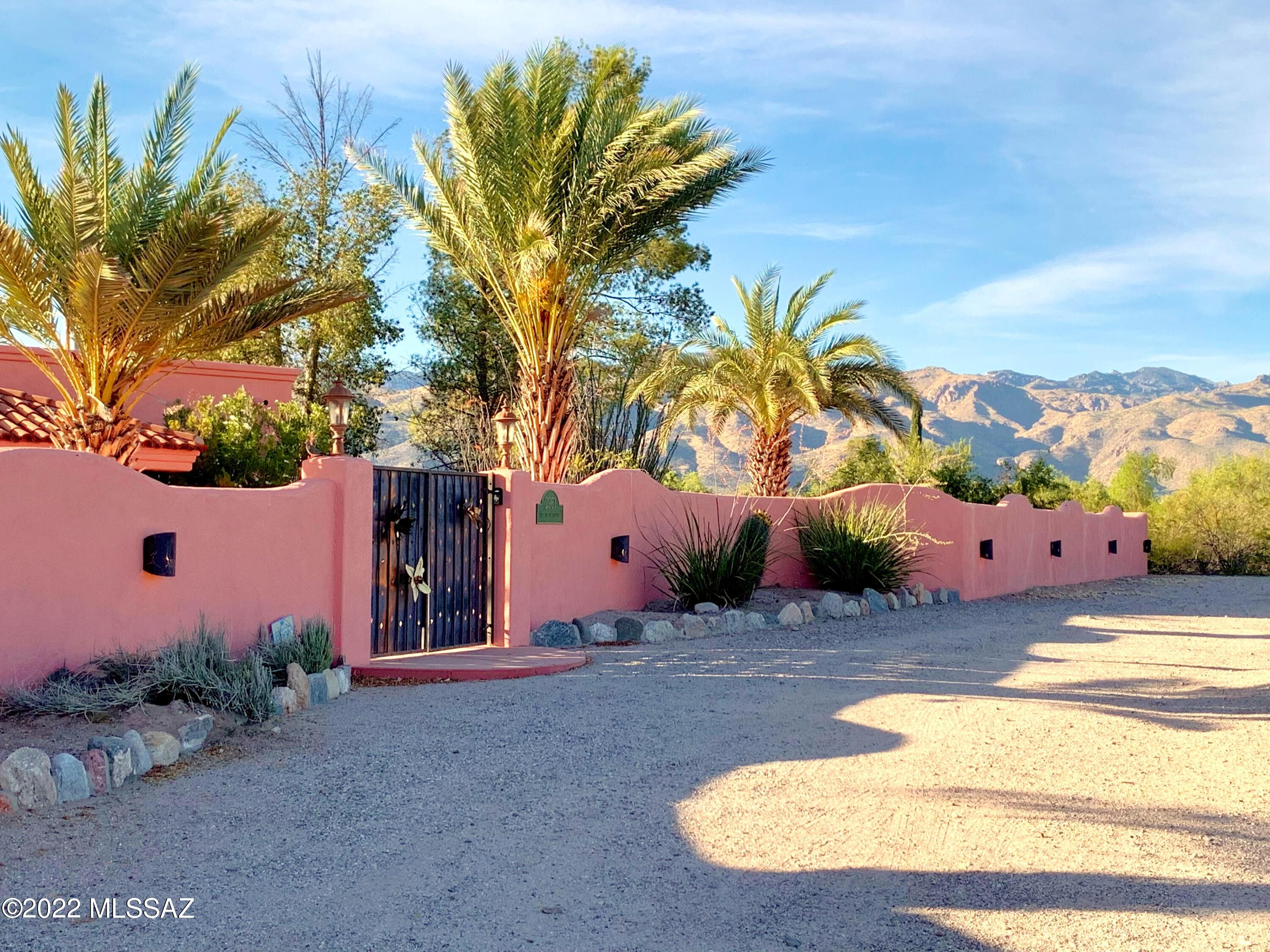 MOUNTAIN Views, Glorious Sunsets by the Pool w/Spa, shaded by a grove of mature trees! An Amazing Estate! Acreage, Huge Walled Yard w/Auto Gated Driveway! Flexibility of no HOA. The residence, originally built in 1961, was transformed after a 2005 rebuild into a grand, contemporary SW Mediterranean. Great use of space! If your home lifestyle centers around Recreation, Luxury & Convenience, this property has all you need! 2020 Chef's Kitchen w/3 picture windows facing the mtns! 2 home offices! Cox Cable, YES!  Massive gathering room plus sep. family rm. Owner's BR Retreat w/resort quality bath! 3 Addlt BRs in main, PLUS, 2 rm, sep entrance guest suite. 5 SUV/Truck Garage, Steel Barn fits full-sized RV&boat! Highly useful, cleared acreage, great for horses, gardening, or other activities!