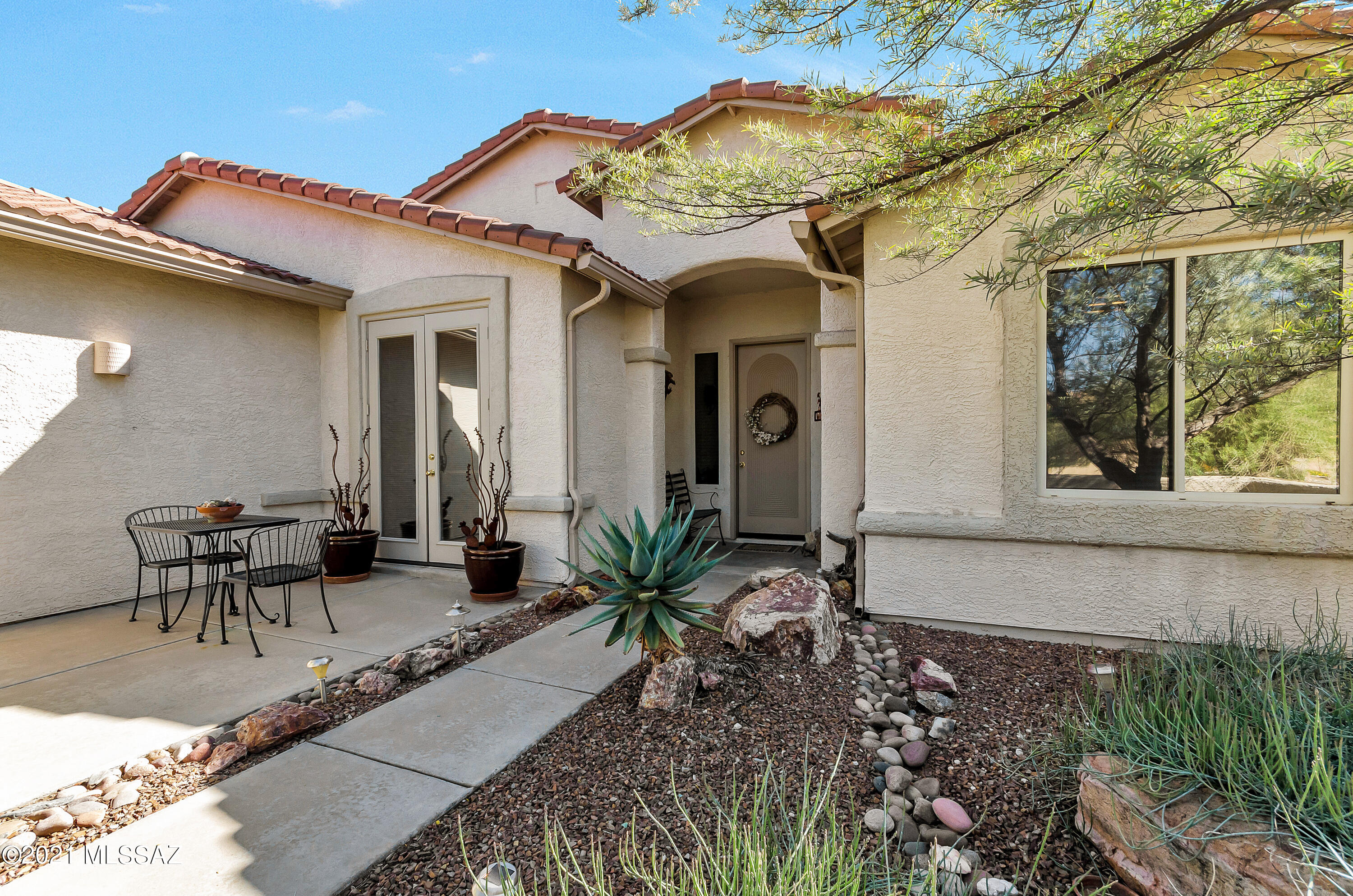 Private oasis awaits new owner! Over 1/3 acre lot includes 1878 sq ft home with 4 BR/2BA. One bedroom has built-in office desk/shelves/wall cabinets/double doors. 9' ceilings & vaulted in great room., with gas FP/built-in entertainment niche. Ceiling fans through-out. Granite tile kitchen counters/island & nook with French doors to front patio. 2 breakfast bars: high counter, and at island. Stainless steel appliances, including fridge. Washer/dryer stay too. Remodeled master bath has added counter/cabinet, tile/glass shower, dual sink vanity & large walk-in closet. 2-1/2 car garage has utility sink, storage cabinets, workbench, and access to backyard. Large spacious back yard has covered patio, pool, spa, rock waterfall feature, wide side yards & view fencing to wash behind property!