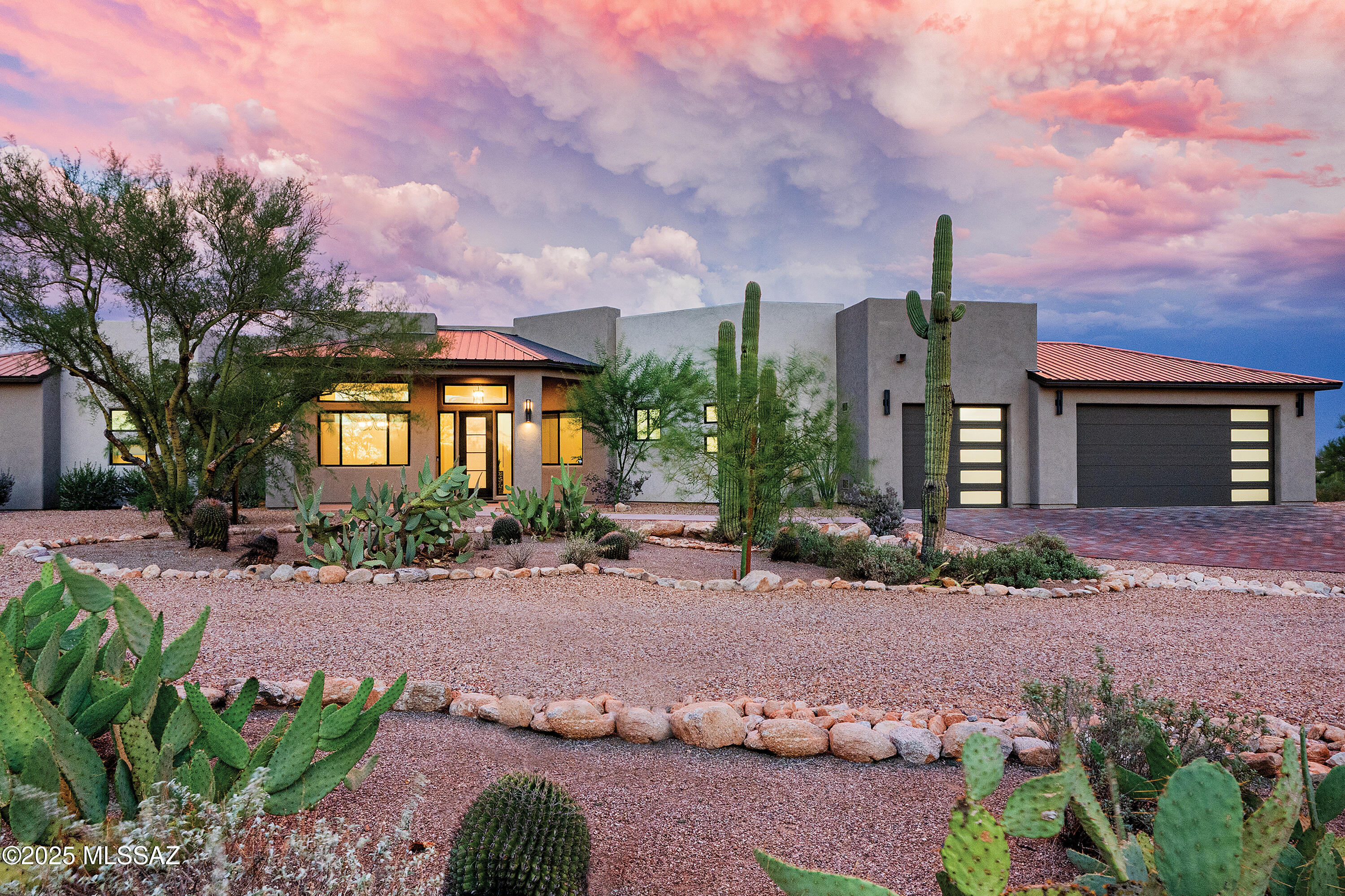 Spacious, outstanding, new (2025) custom Southwestern Contemporary in the Catalina Foothills with 4 bedrooms, 4 ½ baths and 3 car garage, just completed.  Situated on a 1.08 acre view lot adjoining lush Valley View Wash , this 3,559 sq. ft. home is light and bright, with open living spaces including great room and separate family room.  Featuring  modern accents, stucco exterior, multi-hued paver driveway, steel seam and parapet roofing, marquee awnings, super-quiet energy-efficient materials, this lovely new-build is a rare foothills offering.  Mature saguaro and barrel cactus, with new native desert landscape and trees leads to stylish modern steel and glass front door, into the foyer.  Formal dining/sitting room, den/office with expansive windows, into the truly great room with transom mountain view windows, walls of windows, soaring ceiling  with 12' limestone and modern linear fireplace.  Gourmet kitchen with breakfast nook, sleek modern Italian slab cabinetry, 11' quartz island and backsplash, Krause composite farmhouse sink, pot filler and custom range hood vent, Thor and GE stainless steel appliances including 6 burner gas range and large capacity French door/drawer refrigerator.  Split floor plan secludes primary suite including French door access for fabulous view balcony, walk-in closet with built-in cabinetry, custom shelving, palatial primary bath with dual floating vanities, modern soaking tub, large walk-in shower and dedicated tankless water heater.  Expansive lower level walkout family room/guest living space includes kitchenette with gorgeous leather-texture quartz countertops, under-counter fridge and microwave.  Soaring 10' and 12' ceilings, 8' doors, pet-safe engineered oak hardwood floors throughout and solid oak stairs with steel handrail.  Three high efficiency HVAC units, whole-house water treatment system, re-circulating hot water pump, high capacity electrical panel, designer finishes, an abundance of storage and so much more.  See to appreciate this rare find.