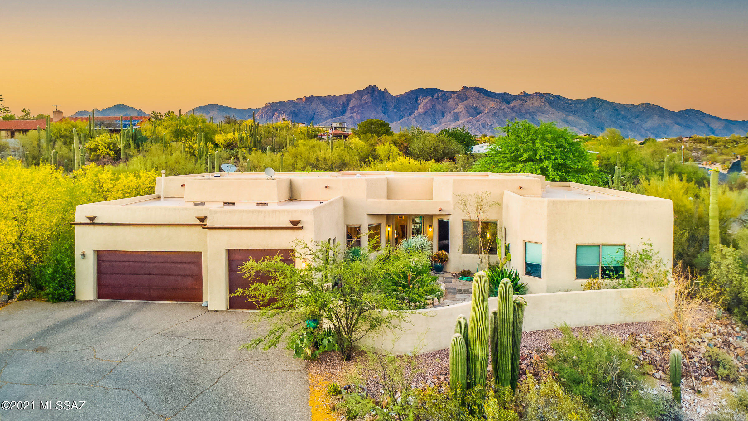 Beautiful custom contemporary home set on 1.5 acres in prestigious Catalina Foothills. Enter this tastefully remodeled home through the courtyard, to double entry doors. As you enter this light, bright, open floor plan you will be met by the high ceilings & finished concrete floor leading into the greatroom which opens to the relaxing back yard complete with pool & rooftop deck to enjoy the city/mountain views, great for entertaining. The open kitchen has SS appliances, custom tiled splashback, wall ovens, beverage center & a 5 burner gas stovetop.
This split bdrm floorplan has 4 bdrms, 3full baths, den, family rm & dining. One bedroom makes a perfect guest retreat with courtyard views & private bathroom. The master is open and airy with large walkin closet & bathroom with double vanities