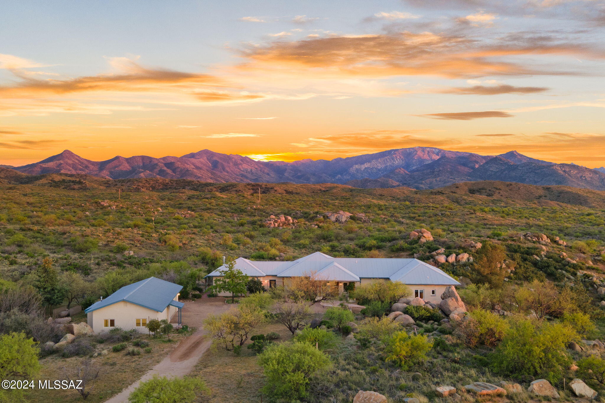STUNNING setting for this custom upscale rustic farmhouse style home in the heart of Oracle! Bordering state land, this energy efficient ICF (insulated concrete forms) built home was designed to capture the serenity of the environment in each room by creating a seamless segue from inside to outside. Every window showcases jaw-dropping views of the Catalina mountains, and you can reach out and touch the pristine state land from your property line! Artist designed home boasts an open floorplan, concrete flooring throughout (with the exception of carpet in the primary bedroom), TALL ceilings and tons of natural light. There is a cook's dream kitchen with gas cooktop, subzero fridge, custom cabinetry, tons of counter space and a huge island topped off with soapstone countertops. The flexible floorplan could easily accommodate a guest wing, several office areas, or whatever your needs may be! The outside vistas will leave you speechless and must be experienced in person. There is a freestanding 2-car garage with an attached art studio (or future guest quarters as it's heated/cooled, has water and electric and is plumbed for an additional bathroom). There is a vegetable garden area, and a fenced side yard for pets. At a 4300' elevation, come view this one-of-a-kind home and experience cooler temps and all that small town living has to offer!