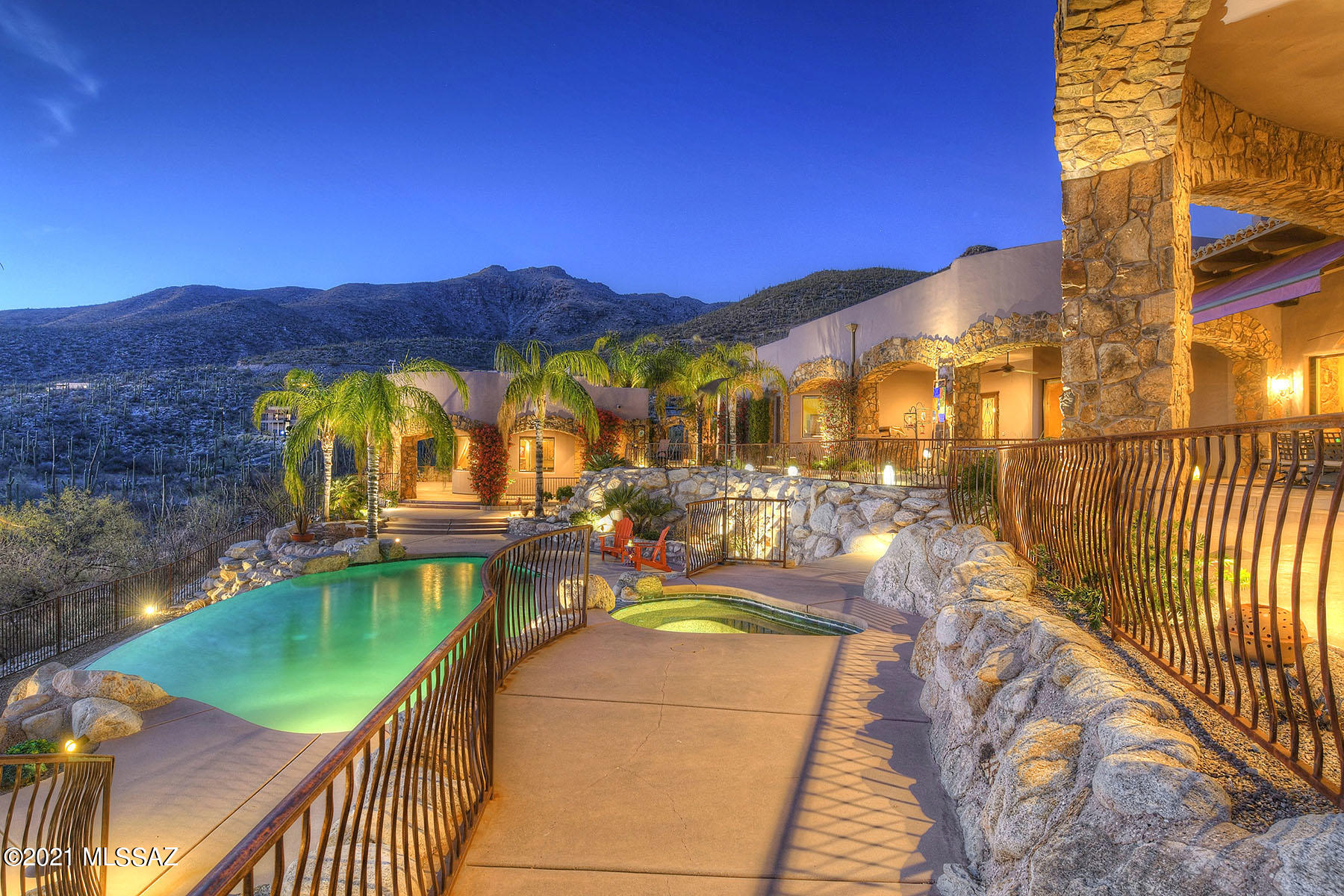 ''Jet liner views'' from this stunning modern Mediterranean style home, high on a hill overlooking the valley below, the city of Tucson and surrounding mountain ranges. Located in NE Tucson in prestigious, gated Mira Vista Estates and located on a 4.29 acre lot, this glorious 5,565 sq. ft. main house and 611 sq. ft. guest house offers long and winding driveway to the top of the hill, private gated entry into glorious walk-ways, patios, pool, spa and arches, BBQ area and views in every direction. Step into the dramatic living room with soaring, cross-beamed ceiling, curved glass eastern window and massive fireplace. Fully equipment chef's kitchen with designer appliances including 6 burner Viking gas stove, Miele steam oven and coffee/cappuccino/espresso maker, seating at the island, custom alder cabinetry throughout including solid core custom arched interiors doors. Gracious master bedroom features rock fireplace and reading area, steam shower, a copper soaking tub and outdoor shower with mountain views. Three car garage with workshop, 111 owned solar panels and so much more to say with so little room to say it. Did we say views, views, views?