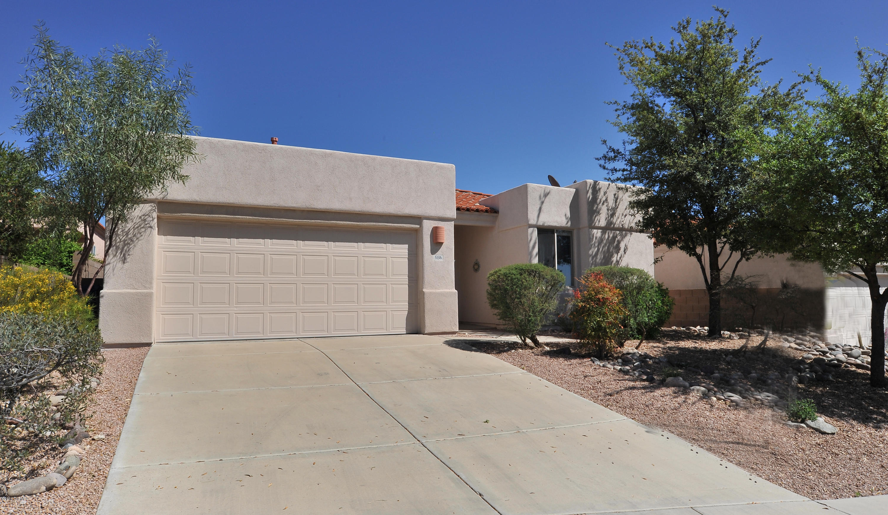 Enjoy Arizona National Golf Course resort living all year long. This AF Sterling 3 bedroom, 2 bath 1,814 Sq Ft home is located in desirable gated Sabino Springs in the foothills of Santa Catalina Mountains. Features include split floorplan, tile w/carpet in bedrooms, open concept kitchen w/both eat in & bar, soaring high ceilings, skylights, attached 2 car garage w/storage & water softener, ceiling fans, recessed lighting, double pane windows, custom Sheer Essence window blinds throughout. Two sliders out to covered private backyard, you can enjoy the serene peace complete with pavers, landscaped backyard & mature trees. Amenities include: gated manned entry, heated community pool & spa, rec center, fitness center, jogging paths & fantastic mountain views. Come view for yourself today. Estate Sale priced to sell.  Lowest priced per Sq Ft and lowest priced home available for sale on MLS in the Sabino Springs Community, listed for $50K below the Zillow.com "Zestimate". Outstanding opportunity for buyers to update to their taste.