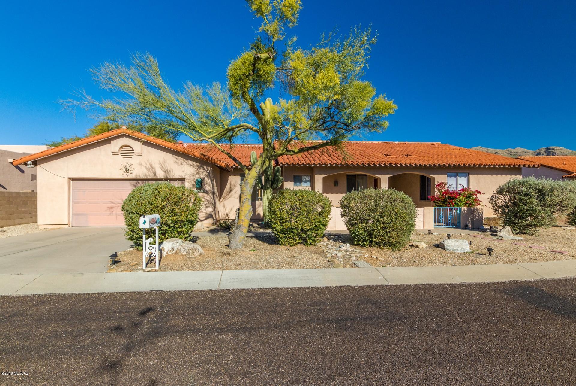 No HOA! Located in the Excellent Tanque Verde School District. This home offers sweeping mountain views, and an open and bright floorplan. Fireplace in the living room to enjoy on chilly winter nights, neutral color palette that will enhance any furnishings. White wash cabinetry, sleek countertops, New Stainless sink and a breakfast bar complete this space. Spacious bedrooms with updated vanities. Master ensuite is complete with walk in shower and separate Upgraded large tub with attractive backsplash, generously sized walk in closet and his and hers sinks. Enjoy your outdoor space with a dip in the pool. Don't miss out on this beauty!