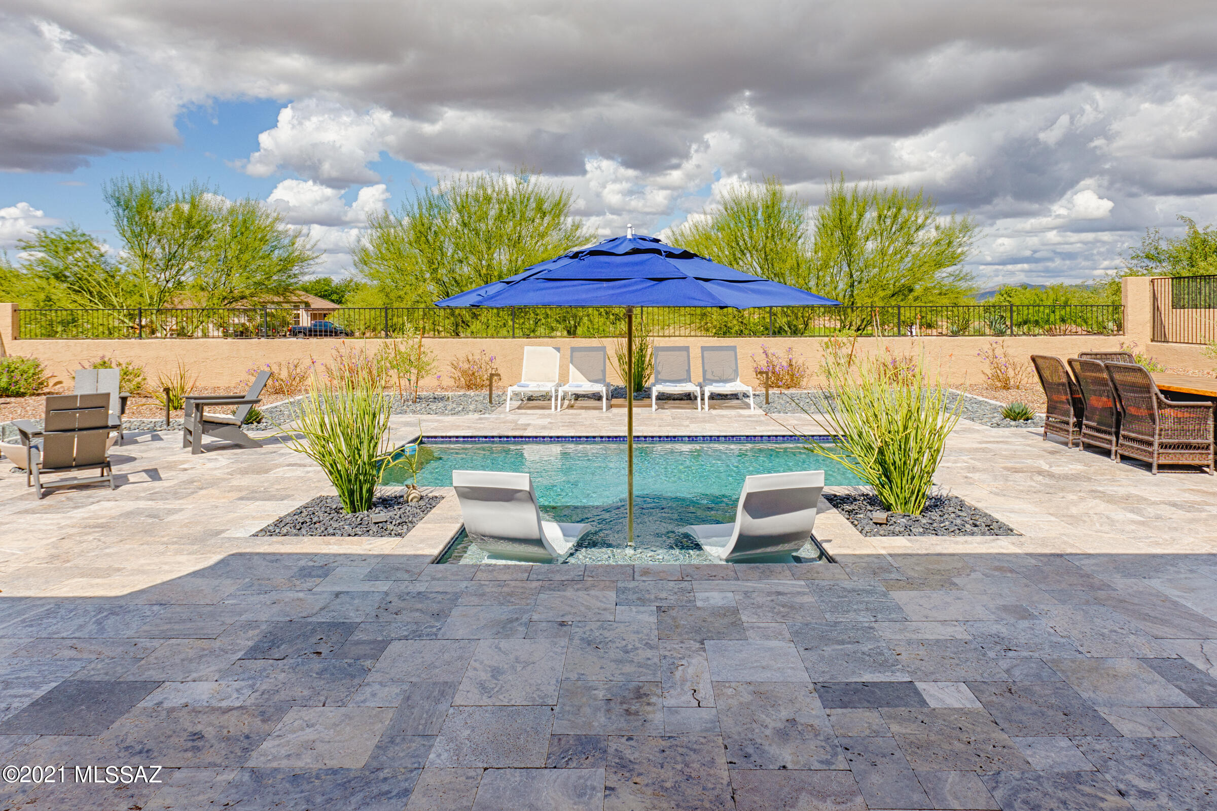 You will instantly fall in love with this stunning and highly upgraded Tesoro – Premiere Series Design D with Amazing Pool in SaddleBrooke Ranch! Upon entering this luxuriously furnished custom designed Contemporary home you will see what an unlimited budget can create! Over $250,000 was spent on making this incredible home a true masterpiece! This home includes 2-Bedrooms En Suite; Powder Room, Great Room w/Media Alcove and 16' (4-piece) movable Glass Wall; Dining Room (which was extended an additional 2-feet with 2-additional windows added); Grand Kitchen Island with adjoining Butler's Pantry and Walk-In Pantry; Spacious Den/Office which was extended an additional 5-feet and can easily double as a 3-bedroom; Owner's Entry Valet with Cabinets; Walk-In Coat Closet; Walk Up Dry Bar; Large Laundry Room; Deep 2-Car + Golf Cart Garage; Outdoor Covered Living Space with Optional Outdoor Living Space "A" making the dimensions 20' X 20" with Travertine flooring, built in fireplace; and 9' and 11' foot ceilings throughout the home!

The Master Bedroom En Suite has 2-Walk-In Closets, Dual Vanities with Soapstone Counters; and the Alternate Master Bath design with custom stone and tiled shower. 

The 2nd Bedroom En Suite has a Walk-In Closet; Shower/Tub Combo, and to top it all off it has the most incredible views of the nearby mountains.

Additional Amenities in the Garage include a tankless water heater; Aquasana Whole House Water Filtration System w/UV light purification system and Reverse Osmosis system.
Additional Amenities in the Kitchen include Soapstone Counters; a CUSTOM paneled Built-In Liebherr refrigerator; and the most beautiful counter to ceiling tile and designer open shelving you'll ever see! 
 
The view from the Great Room into the backyard is truly what defines this home. What you see is travertine and Mexican stone flooring surrounding a beautifully designed custom-built "pebble-tec" pool; fire pit area; lounge and dining areas.  Whether you relax out in the exquisitely designed entertainer's backyard or under the 400 square foot covered patio with a fire roaring, and listening to the soothing sounds of the fountains, you will realize it doesn't get any better than this! 
     
This home can be sold FULLY FURNISHED & TURNKEY for an additional charge. Please inquire with listing agent for details.