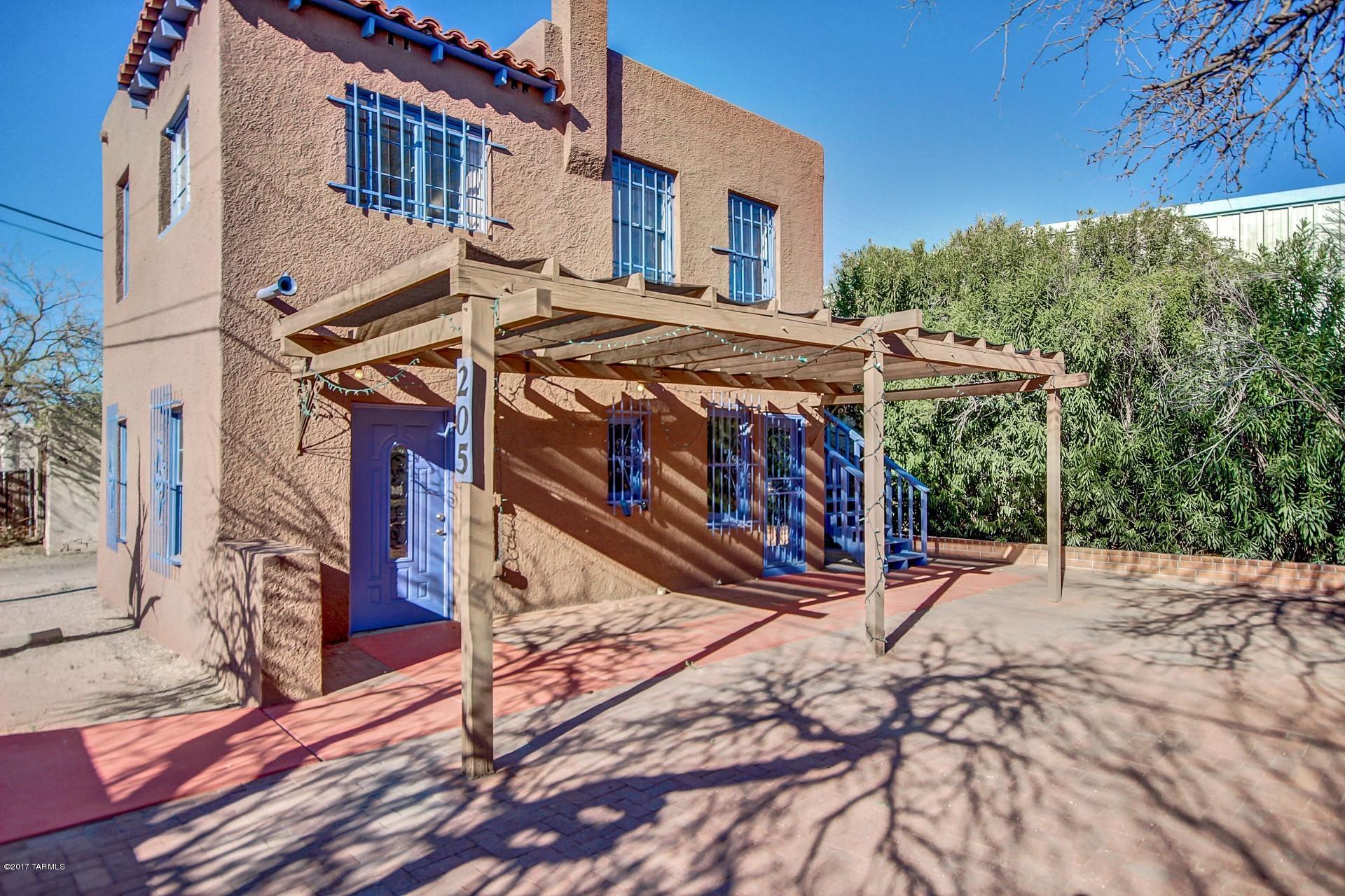 This gem is located on one of the most desirable corner properties in the Lost Barrio Shopping District and offers endless possibilities!! It is within walking distance of downtown and the U of A. Furnished second level for residential rental income and lower level for retail or office rental. Spacious rooms, tile floor, upgraded lighting, contemporary palette, and is beautifully maintained. Home features a charming brick courtyard, covered patio, and security bars. Rented unit upstairs has rented for $850 furnished monthly or $50 a day, bottom unit $650, and fenced portion of lot rented for $350 to a contractor.
Buyer must verify with lender that they can obtain financing due to mixed commercial/residential zoning before submitting an offer.