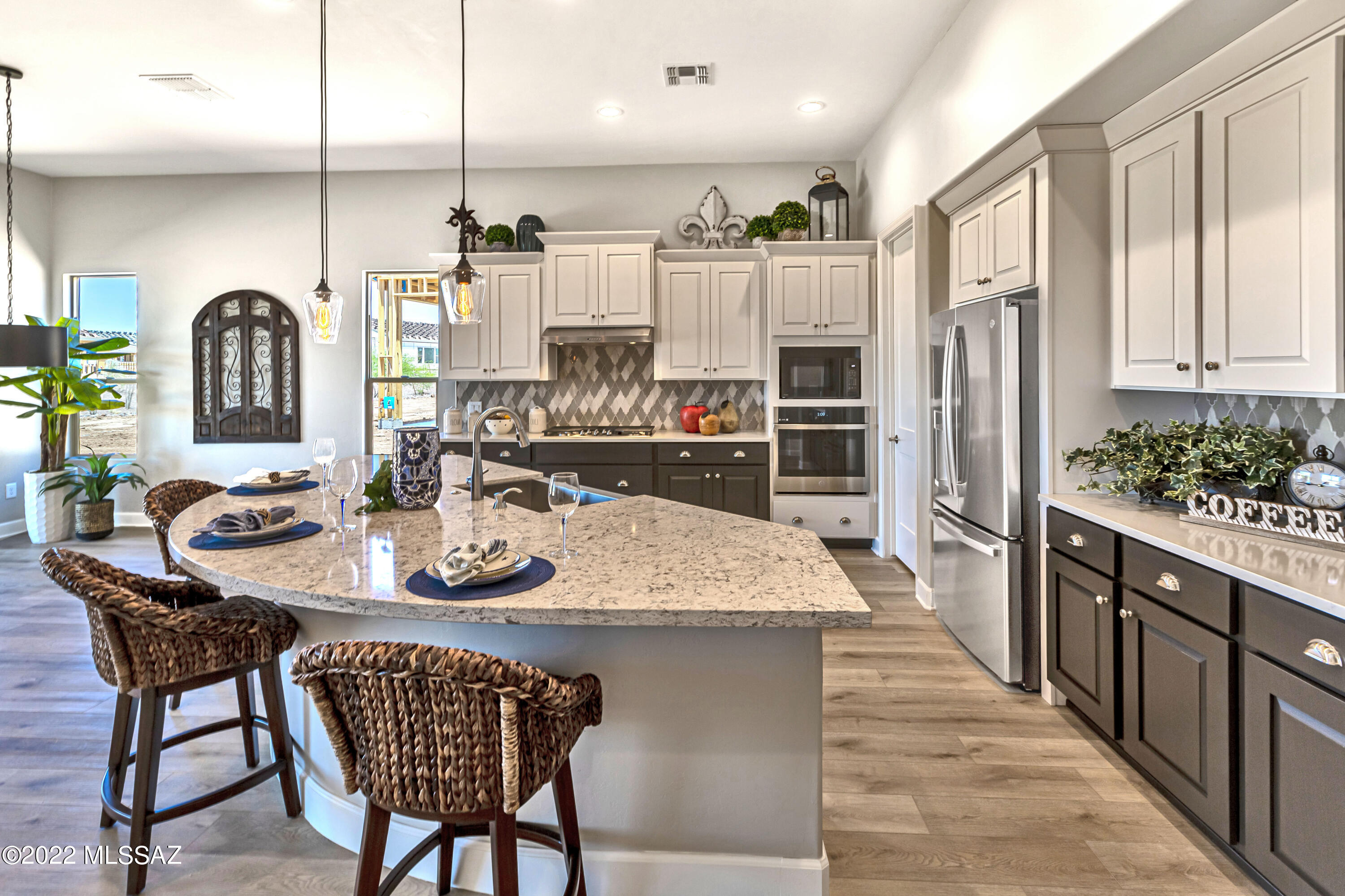 Brand New, Never Lived In! Superior design and exquisite finishes are featured in this Modern Style entertainers' dream home. This magnificent Vienta floor plan in SaddleBrooke Ranch is loaded with upgrades. The open floor plan features many special touches including upgraded cabinetry, luxury vinyl plank floors, Quartzite kitchen counter tops with designer backsplash, upgraded light fixtures and so much more.
Cooking is a chef's delight in this bright open gourmet kitchen that features a generous center island, upgraded stainless steel appliances and plenty of storage including a large walk-in pantry.
Owners' suite offers a luxurious bath, freestanding soaking tub, walk-in shower and a spacious walk-in closet with upgraded built-ins for additional storage The oversized den is great for your home office, separate TV room or library. Two ft extension on entire back of home. Four ft expanded full 3 car garage offers water softener, tankless water heater and epoxy floors. Entertain year round in your spacious backyard with covered patio, enchanting gas fireplace and rolling shades. Front and backyard landscaping to be installed soon.
If you've been imagining yourself in the lap of luxury at SaddleBrooke Ranch, look no further. This is the home of your dreams!