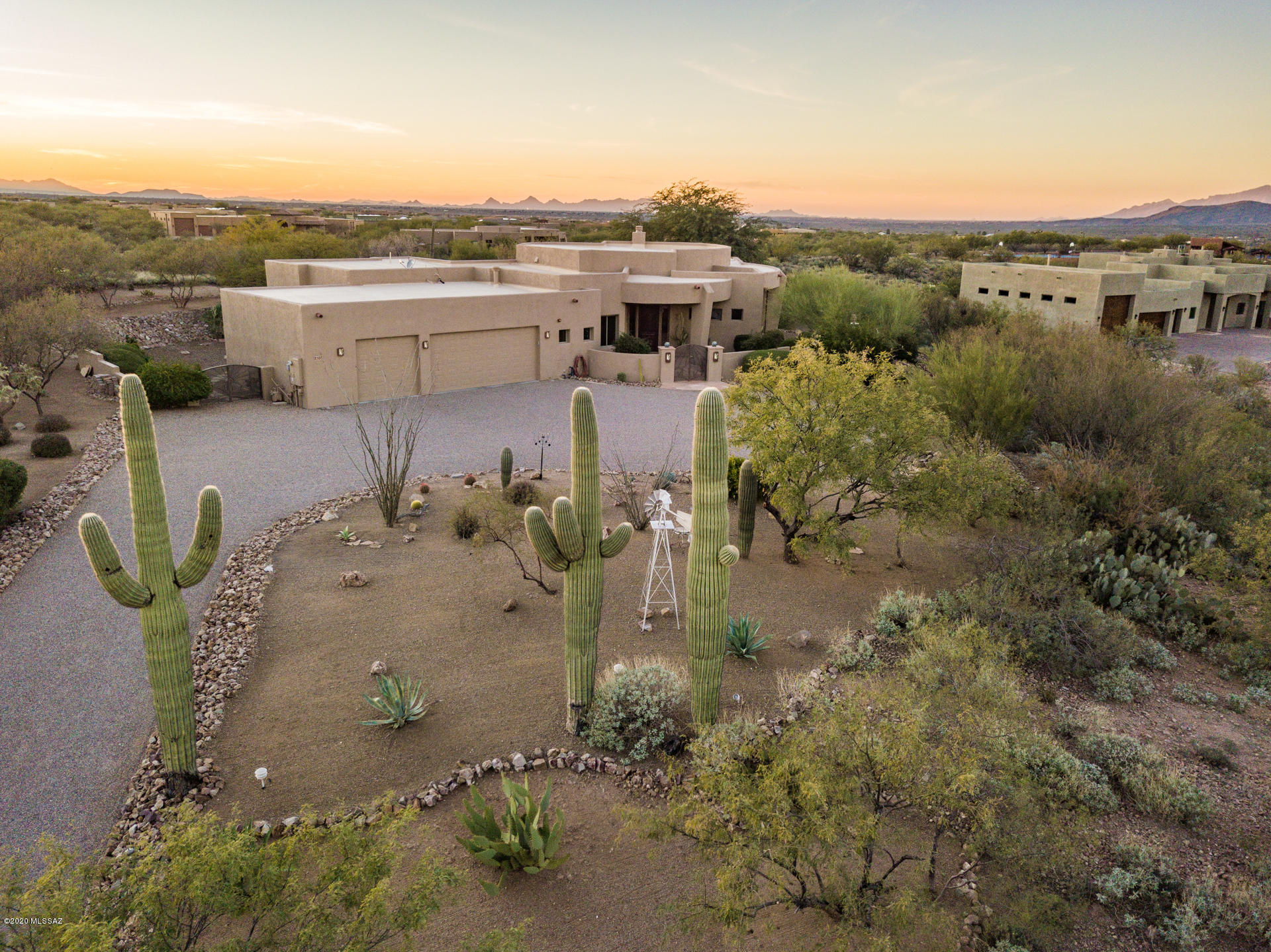 BREATHTAKING PANORAMIC VIEWS OF THE RINCON MOUNTAINS. This amazing 1.66 acre estate offers the privacy, peace & tranquility you have been looking for.  When you step in the front door you will notice the wall of windows in the great room that showcase the mt. views.  The gourmet kitchen would impress any chef w/a Wolf gas cook-top & Wolf double ovens, Knotty Alder cabinets, large center island w/a prep sink & Sub Zero refrigerator. Kitchen opens to huge second patio that offers 2 grills (gas & wood)
outdoor fireplace & plenty of covered patio space for your enjoyment. The formal dining room has built-in Knotty Alder cabinets  w/built-in wine rack & dining area opens to patio . Split bedroom floor plan w/massive master suite that opens to both front & back patio. The master bath has dual vanities, garden tub & large walk in shower. The HUGE master closet has built in shelves/shoe racks that would make you smile.
Second bedroom offers a en-suite bath & beautiful views of the courtyard & mountains.
All bedrooms have walk-in closets for extra storage. The laundry room has Knotty Alder cabinets & a utility sink.
The over sized three car garage offers a large separate storage area. Coyote Creek is an amazing community w/a private Equestrian center that allows residents to board their horse with full care and is connected to miles of beautiful trail systems. Also included with the community is a beautiful community park with tennis, pickle ball, volley ball, basket ball and a great BBQ area.