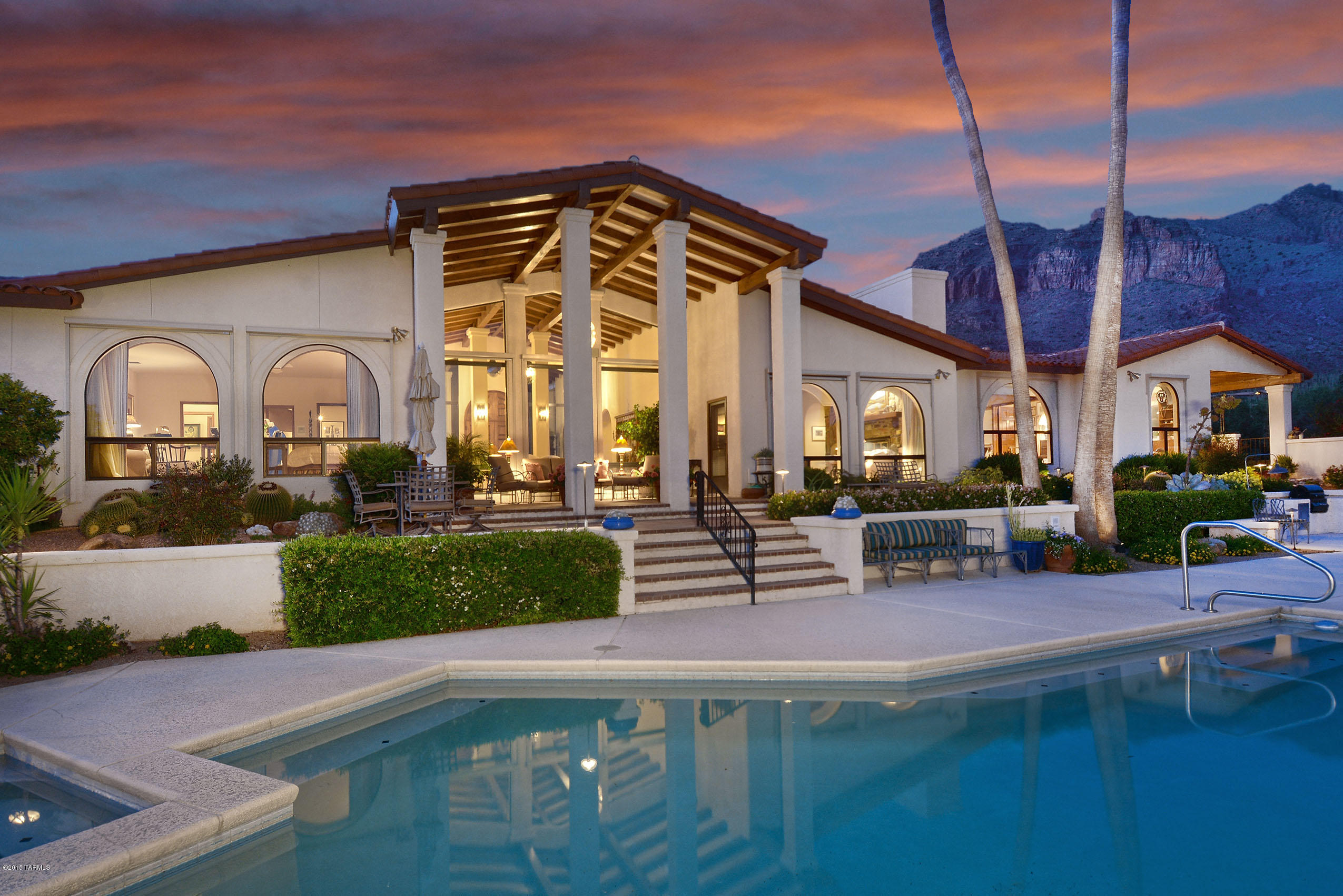 Panoramic city lights and majestic mountain views await you in this custom Catalina Foothills home in the quiet, gated community of Cobblestone. Four bedroom, three and a half bathroom home features an abundance of indoor and outdoor living areas. A grand formal living area as you enter showcases the Tucson valley. The formal dining area is elegant and inviting. Two additional family room/living areas feature a fireplace each and city vistas yet again. The kitchen, laundry/office, and powder room have been recently renovated by local designer Lori Carroll.  The large master suite includes a fabulous dressing room with ample closet and storage space. Two guest bedrooms are spacious with walk-ins. And a third guest suite (currently used as office) is private with its own bath. Professionally landscaped backyard has multiple patio areas overlooking the pool and spa with unobstructed city views once again. The separate "Sunset Garden" is a lovely place to end your day. This desirable location is close to the La Encantada shopping center and some of Tucson's best dining, as well as hiking and nature trails. Please contact agent for appointment to see this exquisite home.