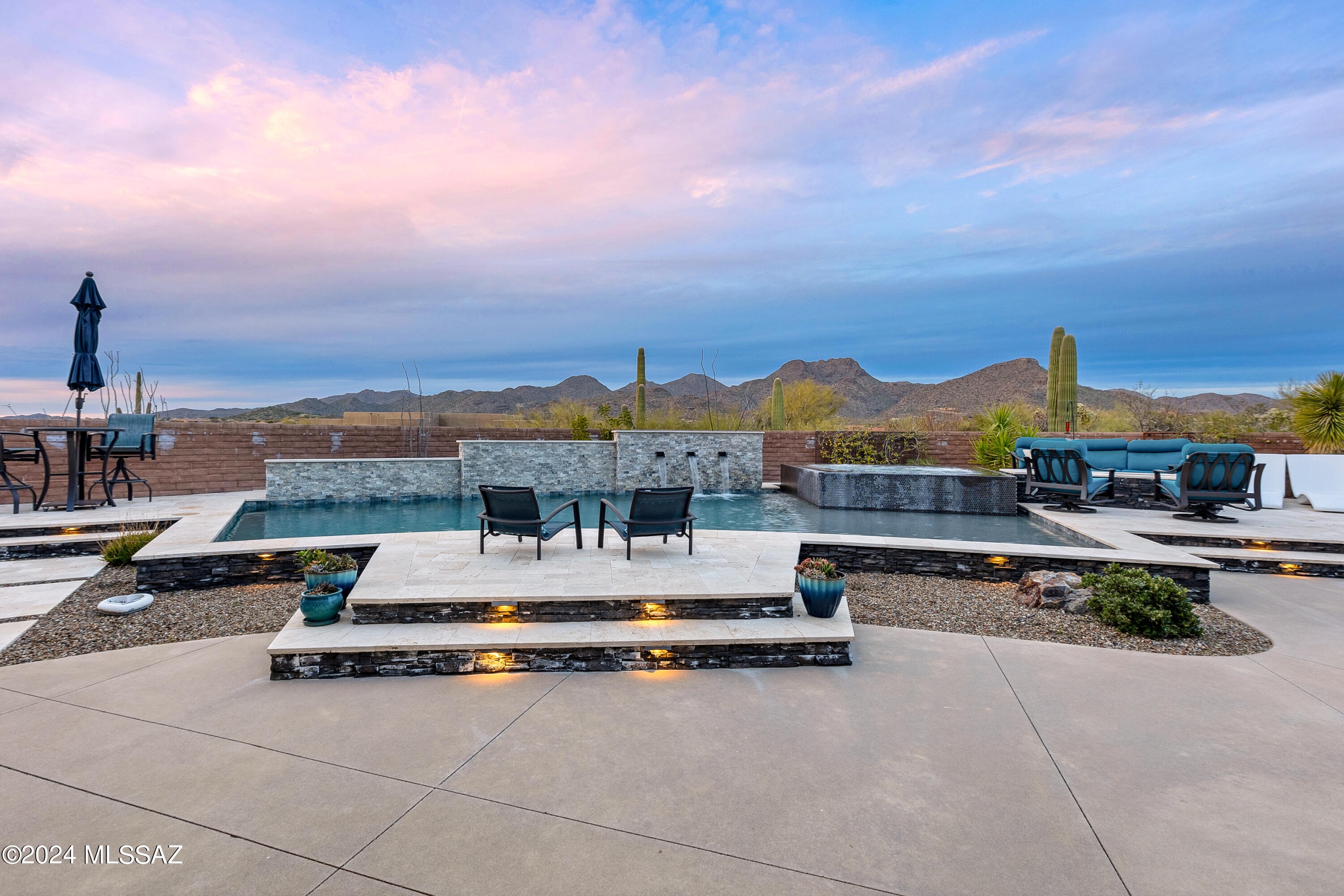Located in the Gated Community of Butterfly Mountain, known for larger homesites and stunning views this magnificent home will not disappoint the most discerning buyer.
From the onset, the concrete & zen rock driveway prepares you for the feeling you experience once entering this home. 
A private courtyard with bubbling water feature greets you as you enter this well-appointed 3 bedroom plus den 2.5 bath soft contemporary home. 
From the wide plank porcelain floors to the leatherette granite counter tops flanked by well thought out accent pieces, the flow of the home is elegant yet comfortable for everyday living.
Walk out through the double sliding doors and you will experience the true beauty of this home.
sitting on 4.27 acres surrounded by mountain ranges. nothing left to do but decide do you sit in the pool, spa, practice your putting, or start the fire pit or maybe cook with you outdoor kitchen? The choice is yours?