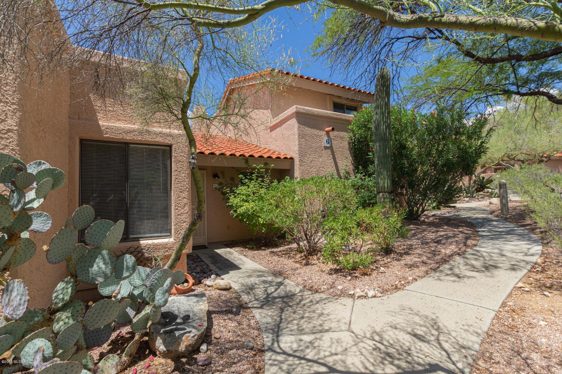 Lovely 2 bedroom 1 bath Townhome located in quiet gated Sin Vacas Neighborhood Tucson. Enter to find vaulted ceilings, neutral paint palette and nicely sized bedrooms. The bright and airy kitchen boasts staggered white cabinetry, SS appliances and granite counters.  Cozy up and relax in the large living area next to the wood burning fireplace. Community features recreation center with kitchen and fireplace conversation area, fitness center, as well as a community pool and spa. Enjoy the  beautiful patio with mountain and sunset views. Enjoy this beautiful area in the heart of the desert foothills, nearby to great shopping and dining at La Encantada mall. Schedule a listing for this gem before its gone!
