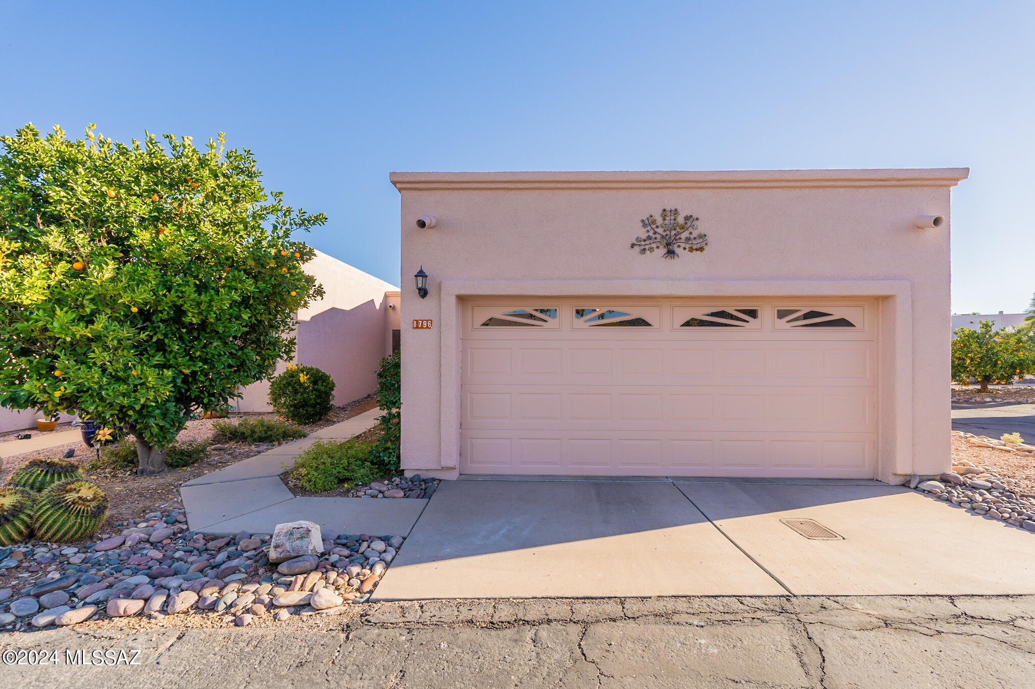 Light, bright, open floor plan with  open desert behind you!  Live the desert dream with plenty of outdoor living space and privacy in your own back yard! Charming front walk way  leads to entry. Freshly painted with warm toned tile throughout. Kitchen is open to the great room and has a pretty arched window looking over into the living area.  Gorgeous new cabinets and gleaming new granite counter tops make it look brand new! Huge great room has sliders leading out to screened in patio and open back yard beyond. The yard is spacious and lush with mature desert plantings. Two beds and two baths are perfect for your winter getaway, including weekend visitors. Center of town location means walking to restaurants and farmers market on Wednesdays. Simply the perfect winter home!