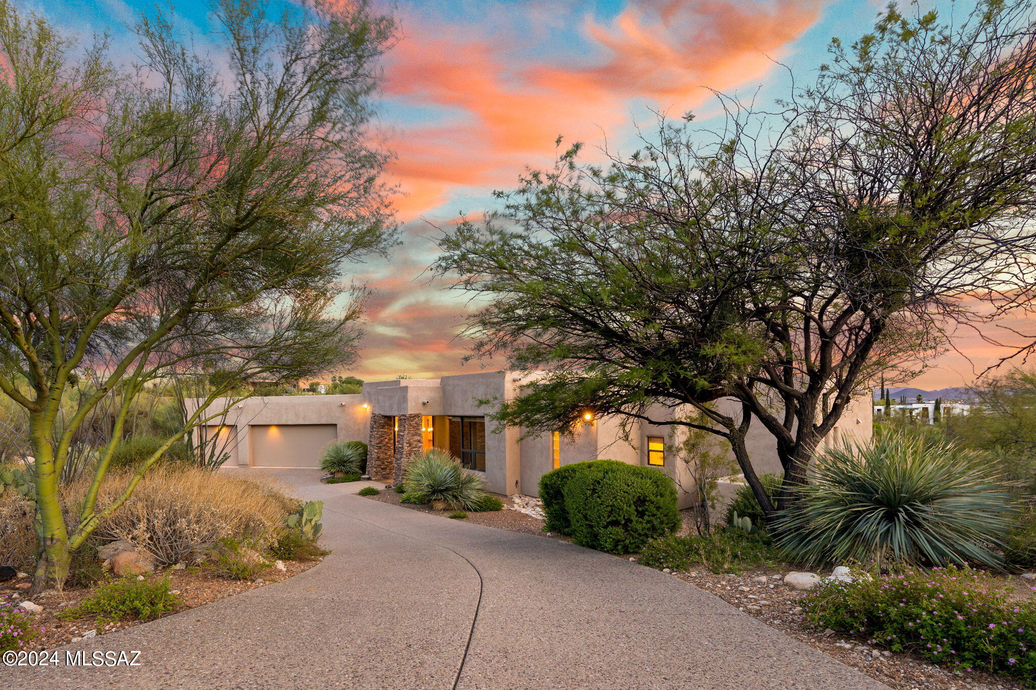 Stunning custom, 3BR/3.5BA + study, contemporary home, set back on lush acre in desirable guard gated Pima Canyon Estates. Quality construction w/designer touches throughout. Hi ceilings, stone flooring & walls of windows capturing dramatic views from every room. Gourmet island kitchen incl granite counters, top of the line SS appliances, gorgeous cherrywood cabinetry, breakfast bar & opens to family rm featuring stacked stone corner fpl. Spacious living rm w/stacked stone fpl & expansive glass sliders that capture panoramic views & beauty of the desert, bringing outside in. Formal dining rm adjacent to custom designed bar, ideal for entertaining. Primary BR suite inc slate fpl, huge walk-in closet w/built-Ins & luxurious ensuite BA. Each of the 2 add'l BRs has its own private bath South facing bkyd overlooks magnificent city, mountain & sunset views. Covered patio, sparkling pool/spa, blt-in BBQ & fire pit, perfect for enjoying Tucson's outdoor life style. Conveniently located laundry rm w/sink, cabinets & washer/dryer. Exposed aggregate driveway. 3 car garage w/ epoxy flooring, built-in cabinetry & workshop. Close to restaurants, shopping & hiking. Location easy access to all of Tucson.