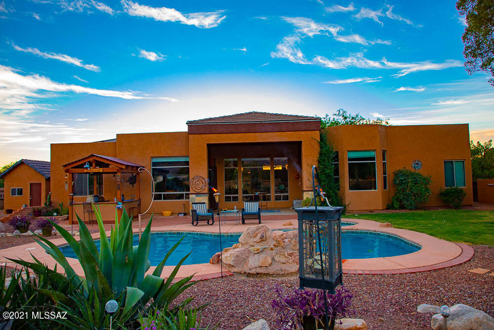 Enjoy the stunning views of the Catalina Mountain range in Resort Style Living! This great 3724 sq ft home is gated and rests on over an acre fully fenced property, and features 5 bedrooms, 4 bathrooms, 3 living areas, 2 dining areas, and 1034 sq ft detached 3 car garage. Resort style backyard featuring a beautiful pool & hot tub, gas firepit, built in BBQ cabana, sports court, storage room, and plenty of room for an RV and Boat! No HOA. This home is move-in ready and offers a flexible floor plan for a variety of living situations including a multi generational suite or income rental. Less than a mile to National Forest land with over 200 miles of hiking, biking, horseback riding trails, and minutes from shopping, dining, and entertainment!