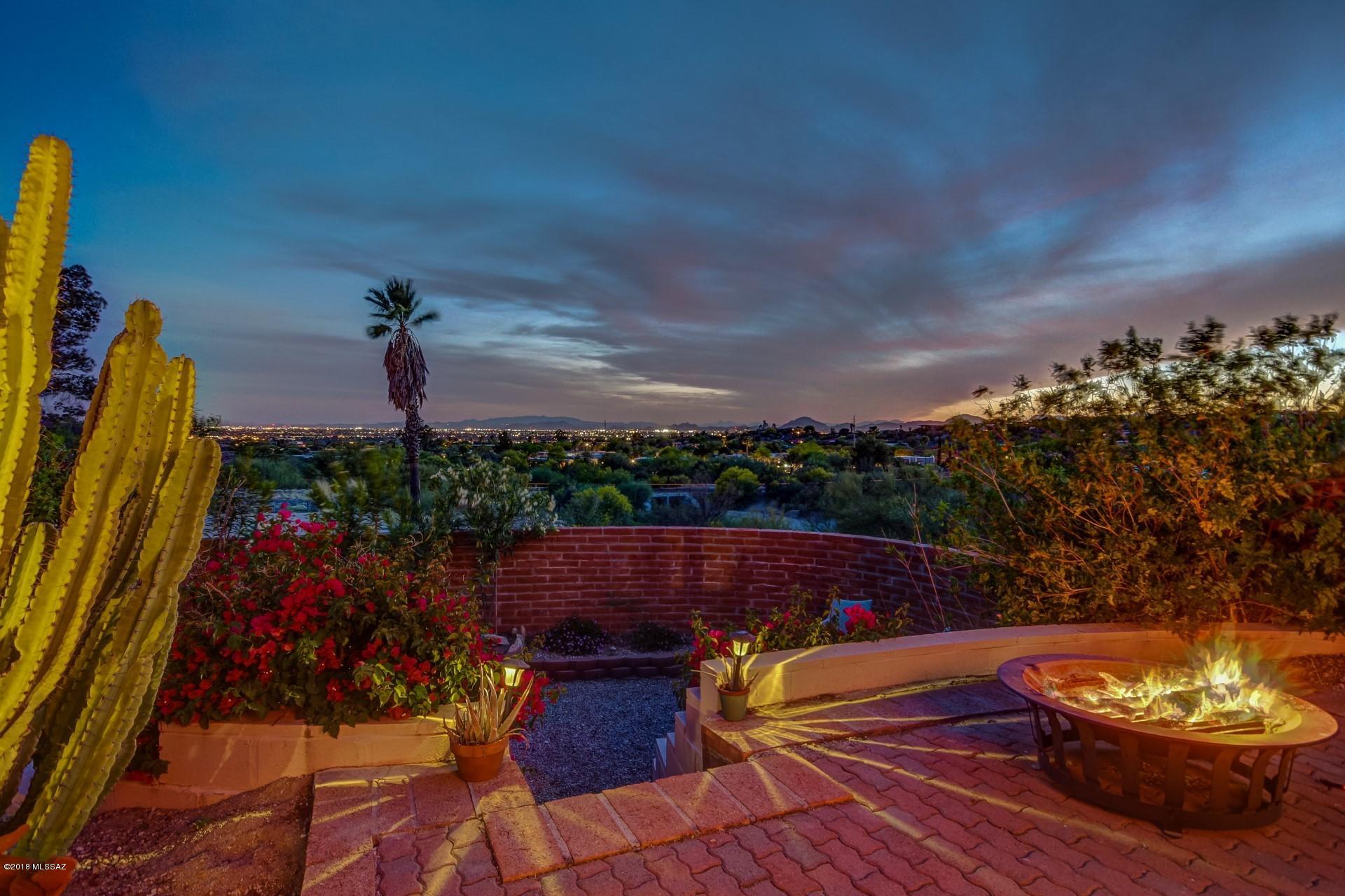 Captivating mountain and city views. Gorgeous home resting on over 1/2 acre and situated in a quiet cul-de-sac. Enjoy your mornings on the front patio or an evening sitting in the swing gazing at those amazing mountains. Formal living and dining rooms and family room with wood burning fireplace. Updated kitchen with corian countertops, gas stove and stainless appliances. Rest peaceful at night in your master suite as you fall asleep with the views. Bathroom vanities are executive height with updated countertops. The private backyard oasis is perfect for entertaining. Sparkling pool, bocce ball area, fire pit and city lights. Close to schools,  including top-ranked BASIS Tucson North, shopping (Whole Foods)and restaurants. Fantastic location in the desired foothills.This home is a must see!