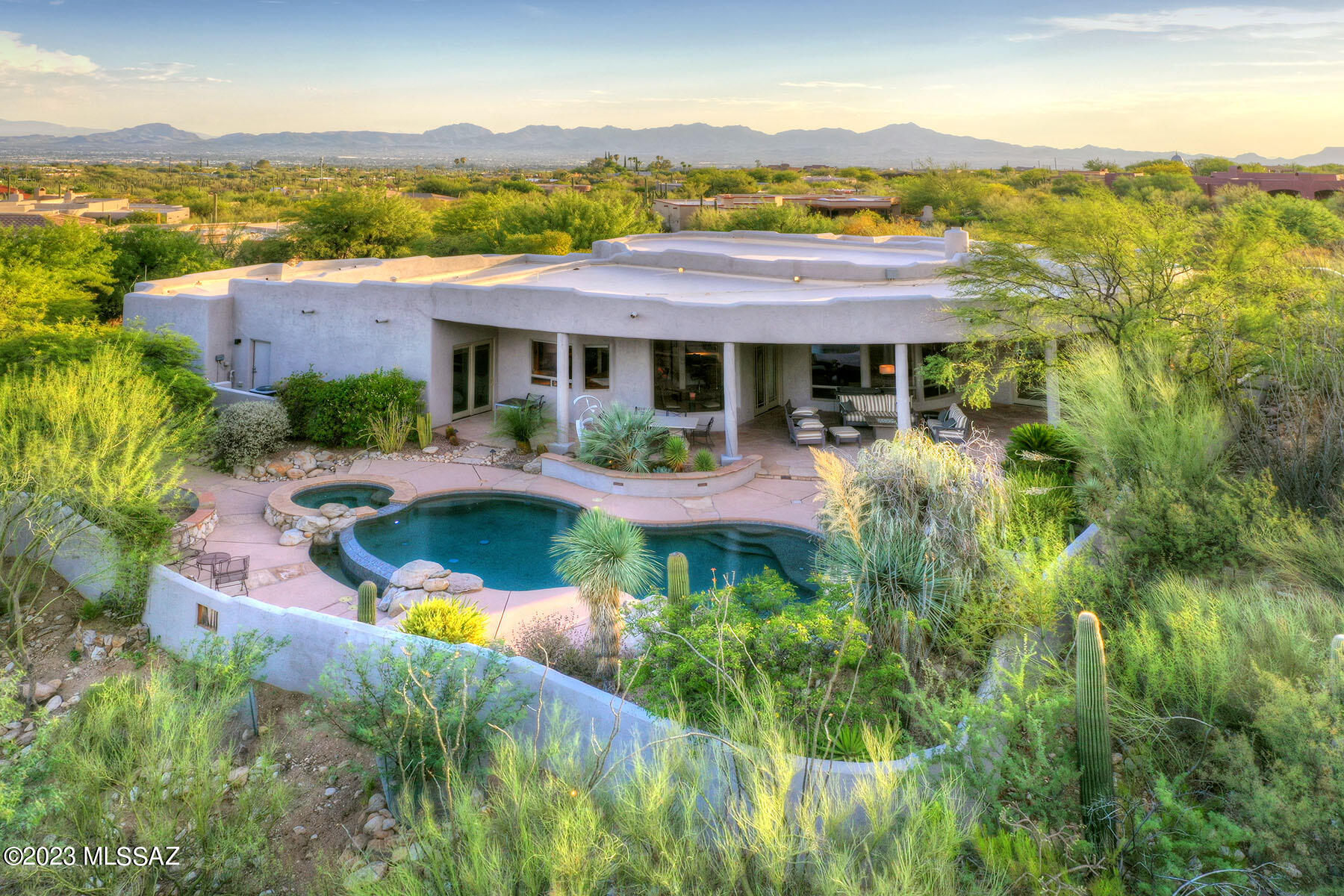Nestled within the serene beauty of Tucson is a stunning residence that encapsulates the epitome of luxury living. Situated in the sought-after gated community of Pima Canyon, the property offers a blend of comfort, elegance, & casual living.  
This 4BR/4BA home stands as a testament to timeless architecture & meticulous craftsmanship. The lushly landscaped front courtyard provides an aura of tranquility & privacy & sets the stage for what awaits inside. The open floor plan provides a seamless fusion of spaces that allows both intimate gatherings & entertaining. Designed to showcase the stunning MTN. views & mature desert landscape, the property features high ceilings throughout plus walls of windows to create an inviting ambiance that bathes each room w/ natural light. (Con't) This residence is the well-appointed kitchen that combines functionality with aesthetics. The generous center island provides ample counter space, and serves as the ideal gathering place for entertaining or family meals. Complete with professional grade appliances, an expansive walk-in pantry, and abundant cabinetry, the kitchen is a dream come true for culinary enthusiasts.

The living areas seamlessly transition to a private outdoor haven with picturesque mountain views that serve as a constant reminder of the breathtaking beauty of the Tucson landscape. 
The focal point is the exquisite pool adorned with a tranquil water feature and an adjoining spa. Whether you seek to bask in the sun's warmth, unwind in the cool embrace of the water, or relax in the deep shaded patio, this backyard retreat offers it all.

The split floor plan effortlessly accommodates families, or hosts and visiting guests. The primary bedroom is a sanctuary of comfort, offering plentiful space and a cozy fireplace that caters to relaxation. Two guest rooms located in a separate wing have en-suite baths.  

In essence, 7308 N Mystic Canyon Drive embodies Arizona living at its finest. From its secluded location within a gated community to its meticulously designed interiors, every aspect of this residence speaks to a life of sophistication. If you're seeking a haven where modern luxury meets natural beauty, look no further than this address in Tucson's prestigious gated community.