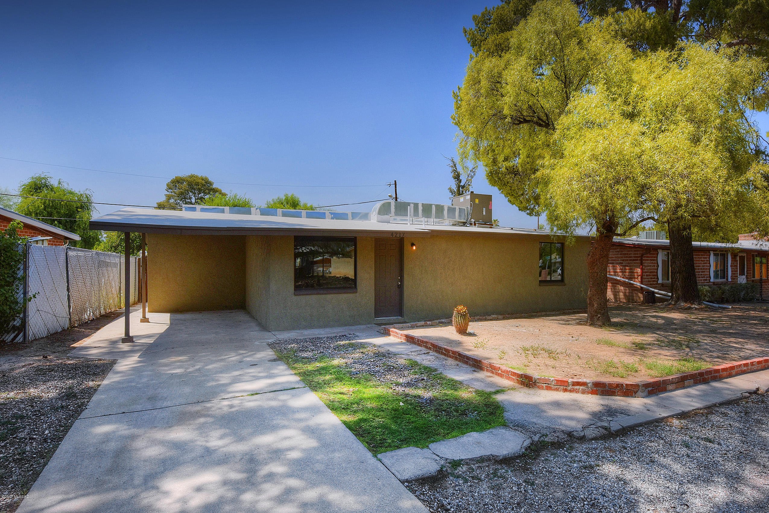 Must see gorgeous single family home! Located six minutes from Tucson mall & restaurants; seven minutes from I-10! This charming home is a 3 bedroom 2 bath contemporary sleek style home. Recently renovated in July 2017. This beautiful home has a lot of new features that includes (flooring, doors, two tone paint, stainless steel appliances, stucco) Seller will provide new stainless steel appliances including gas range OTR microwave & dishwasher with accepted offer. It has a delightful pool in the back yard perfect for summer fun! Home has a brand new AC unit that blows super cold air. Roof has a two year warranty. Don't miss out on such a stunning, turn-key home!!!