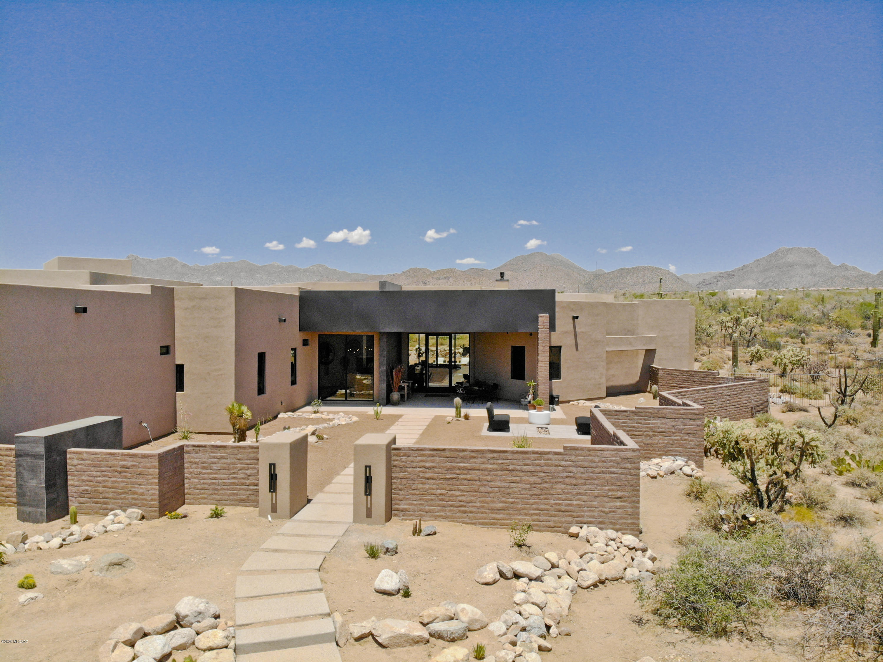 Simply SENSATIONAL contemporary styled home with a MASSIVE 4,500 sq. ft. garage that's perfect for a car enthusiast, RV owner, artist, or other hobbyist. This phenomenal luxury home is sited on a large 4.15 acre lot & delivers unparalleled craftsmanship from 4th generation builder John Herder who is renowned for his quality & attention to detail. Situated within the gated community of The Estates at Tortolita Preserve, you'll appreciate the protected views of the Tortolitas & Tucson Mountains. That enormous garage offers heating & cooling, covered RV storage, workshop space, compressed air lines, addt'l laundry hookups & so much more! A commercial grade rear sliding door system & floor to ceiling front windows deliver amazing mountain views! Now fully completed & new pictures coming soon!