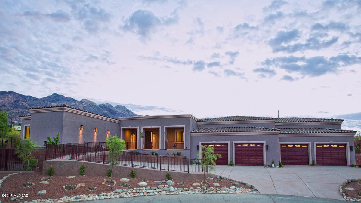 Never occupied this home is designed for the family.  Large grass back yard with magnificent mountain views.  Extra large pool and spa completely fenced off for the safety of your children and guests.  Each bedroom has its own bathroom and walk in closet.  The office comes with built in desk and cabinets.  Oversized four car garage and large storage room.  Walk in pantry in the kitchen.  Maple cabinets throughout with solid core wood doors.  Entire home is tiled in wood look ceramic tile.  Fully landscaped.  The home is centrally located in the prestigious gated community of La Paloma on a very quiet cul de sac.  Take note of the extensive masonry work.  Trustee of the owner is a licensed real estate professional. Seller may carry back with 25% down. qualification for a loan of at least $830,000.