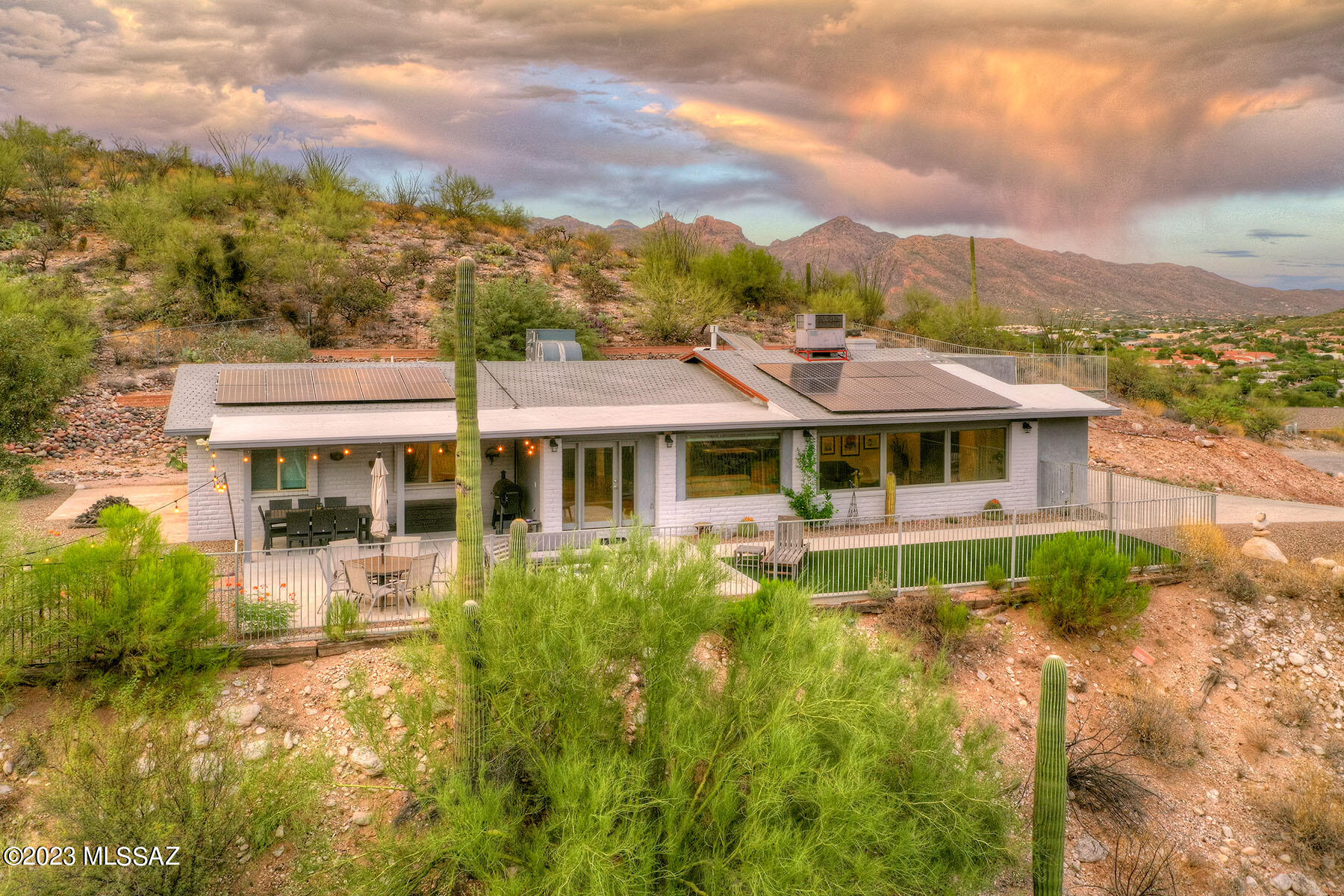 Nestled in the cul de sac at the serene Quail Canyon Foothills, this rustic-modern gem features 3 beds+office, 2.5 baths. Its open layout centers on two islands, ideal for gatherings. Exposed beams add to it's rustic charm.
Perched on a hill, enjoy sweeping city, mountain, and saguaro views from all picture windows. 
Views from dinning, family room, kitchen and bedrooms . Complete privacy on this 360-degree property, with a pool-ready yard and a gas fire pit on the patio. An oversized garage adds convenience.
Indoors, a spacious pantry, room for a large fridge and laundry room with cabinets and double sink. The kitchen boasts SS appliances. Near Sabino Canyon trails, upscale shopping, and dining. Save on energy w/solar power. New roof Sep 2023, newer AC. and so much more! Owner/Agent