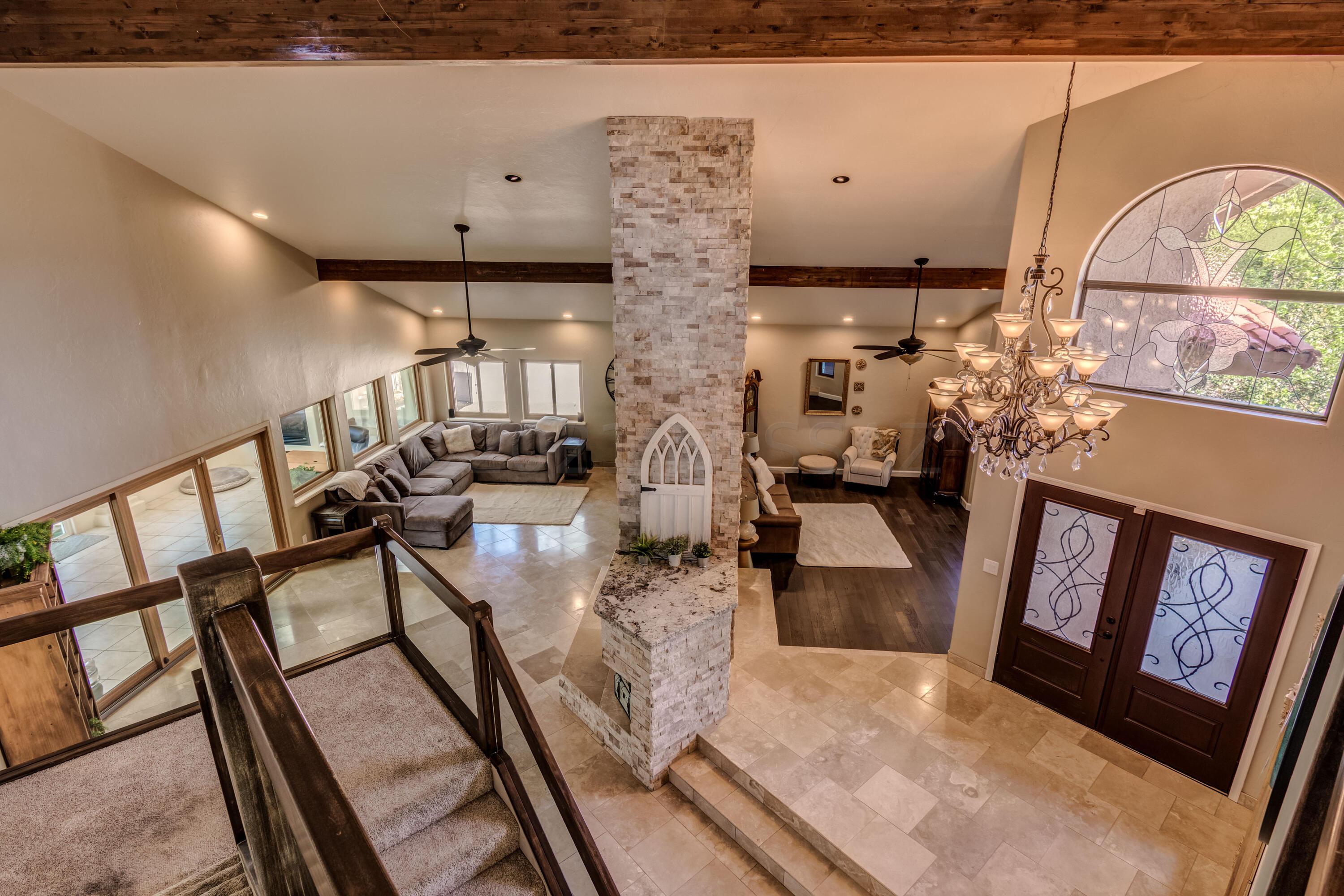 Range price listing!! Seller will entertain offers between $979,900 to $1,029,900. You'll love this Contemporary style home with a Desert Oasis setting in the prestigious La Cebadilla Estates on over 3.5 acres!! This Elegant 4 bed/ 3bath home will absolutely stun you with its modern and dazzling finishes while offering spacious interior, generous sized rooms, travertine and engineered wood floors w/ soaring vaulted beamed ceilings. The Gourmet kitchen boasts of beautiful custom cabinetry, pristine granite countertops, Kitchen Island w/induction cooktop, pantry and stainless steel appliances.  Separate Living and Family room with a captivating stack stone see-through fireplace. Enormous Arizona room can be used as office or for guests. Plush Jack & Jill Bath off upstairs bedrooms. Smart Light switches in living room, kitchen and owner's suite Spacious Owner's Suite has a private balcony to relax w/ breath taking mountain views. Owners bath w/ dual vanity, granite countertops, travertine tile, walk-in closet separate tub and luxurious walk-in shower. Huge and lushly landscaped backyard features a sparkling Pebble Tec pool oasis and spa, an outdoor kitchen, ramada, a brick paver covered patio and artificial grass. Access to private community lake. This home is a truly an entertainer's paradise! Upscale living at its finest!! You are buying a lifestyle, not just a home. Come take a look at your home today!!