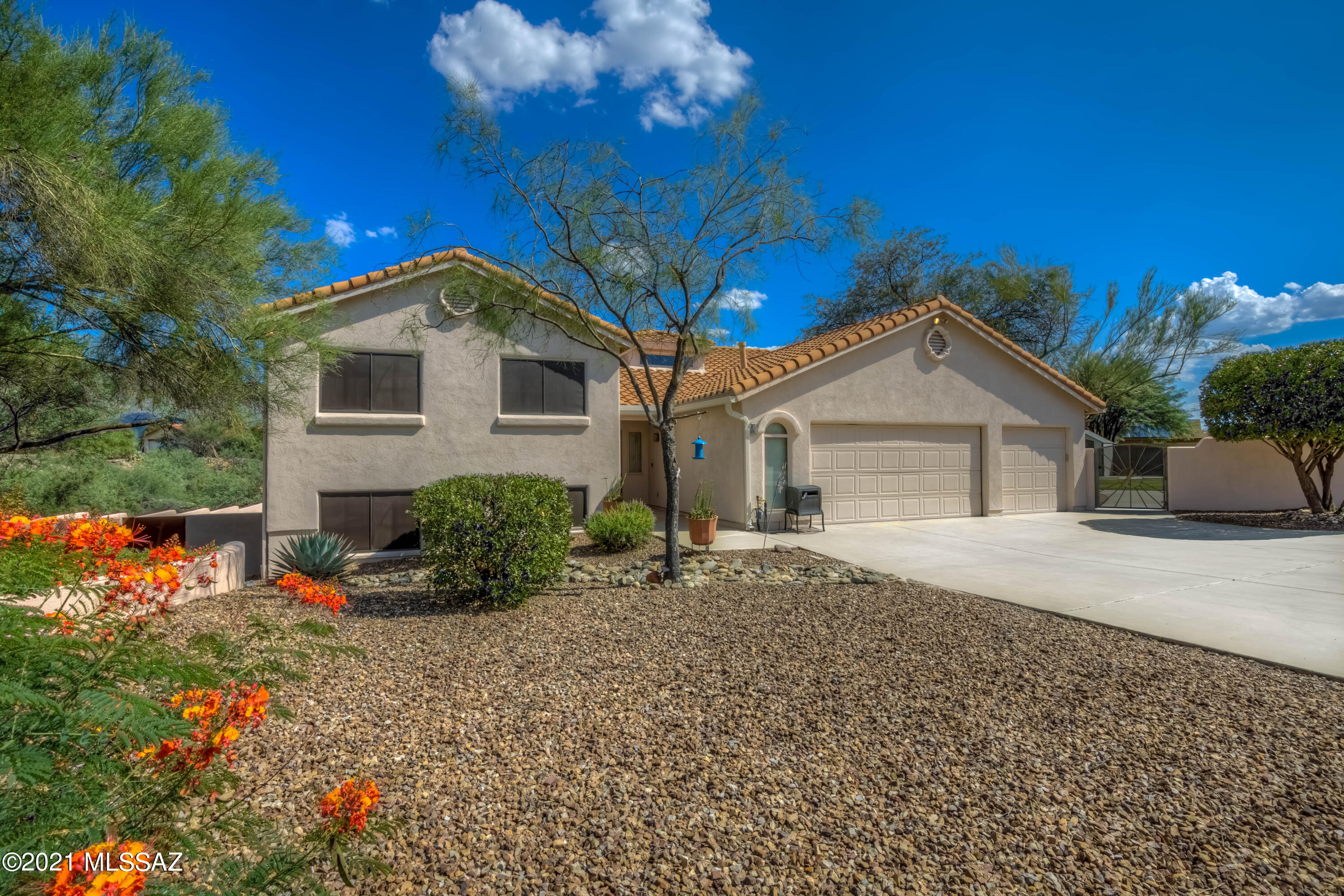 Hurry this one won't last long! Majestic Catalina Mountain Views and Tucson city lights abound this gorgeous 1.19 acre custom home in Oro Valley. Large PebbleTec Pool & surrounding lower entertainment space completely re-designed/remodeled in 2018. Park-like backyard is large & flat w/mature citrus trees, two rose gardens, & real grass for your entertaining pleasure. Great for parties and even weddings! 3 Incredible custom gates, were hand crafted by Ken Webb of Quiet Bear Art. Inside you'll find a beehive fireplace to gather family and friends around enjoying the view. Up 7 steps to the primary bedroom that has a beautifully remodeled modern bathroom. And only 7 steps down you your very own walk out basement to the pool and 2nd entertainment area. There are 2 guest bedrooms up and 2 bedrooms down as well as the large family room w/a custom wet bar ready for entertaining. The other 2.5 guest bathrooms have also been remodeled with gorgeous Italian tile. The kitchen is waiting for its next owner to make it their dream kitchen. It has original Jenn-Air appliances that are still going strong, dishwasher is newer, center island, loads of cabinet space, large pantry closet, and the breakfast nook overlooks the Catalina Mountains. HVAC system was replaced in 2016 and is the top of the line Lennox. Super low HOA's only $7 a mo. Don't miss this opportunity to live in Monte Del Oro!
