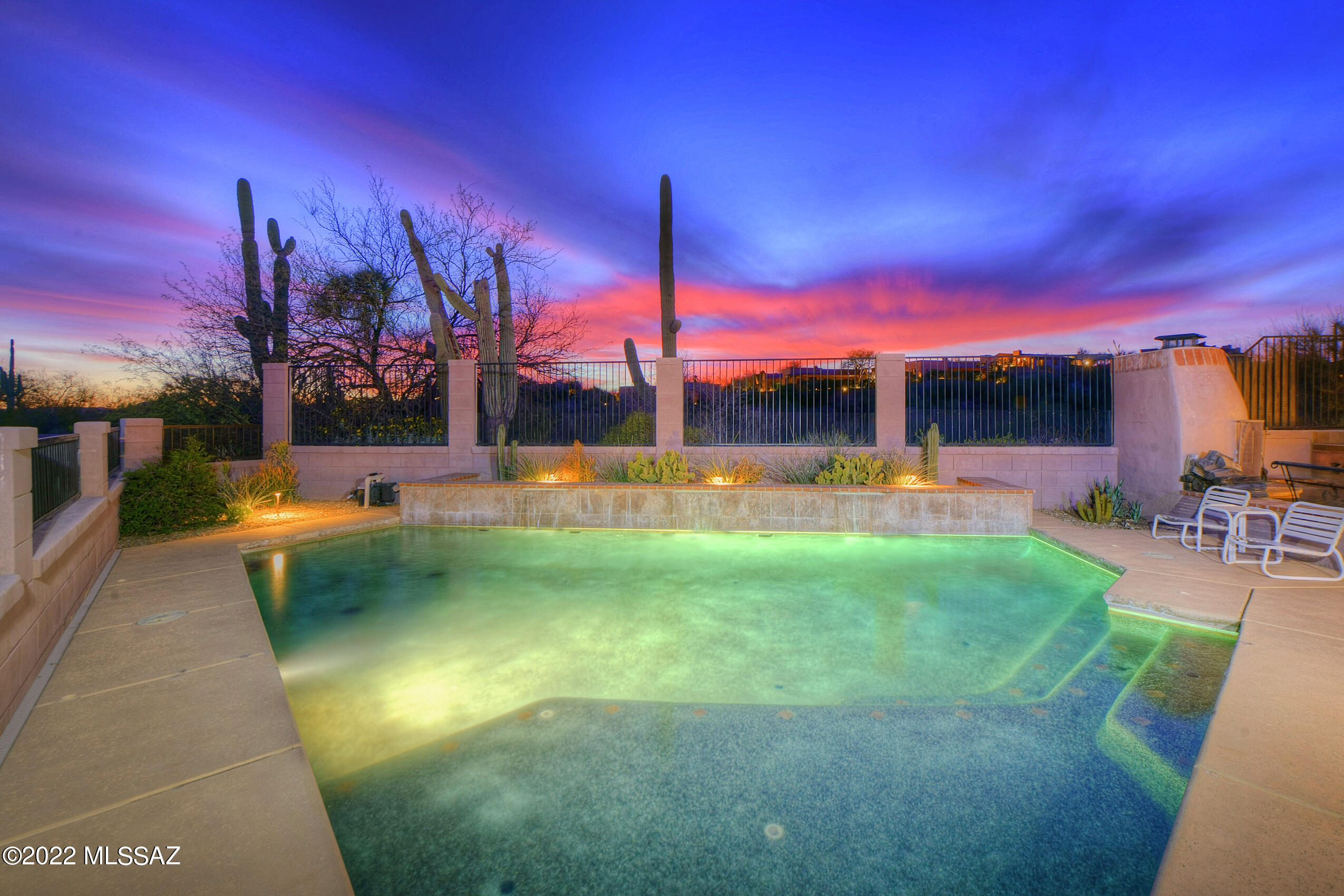 Premium lot bordering common area in guard-gated Villages of La Paloma with unparalleled privacy & sensational views. This one-level residence has the most popular floor plan-2656 SF, 3 bedrooms, an office & a 3-car garage.  Bright entry, exceptional great room w/ stacked stone fireplace & huge windows filling the room w/ natural light. Upgraded kitchen w/ center island, granite countertops, stainless steel appliances & pantry. Breakfast nook w/ sliding glass doors to separate patio w/ distinctive cactus garden & hot tub. Split bedroom floor plan w/ 2 guest rooms, guest bath on one side of the home & master suite & office on the other side of the home. Deep covered patio off of the kitchen & great room provides an outdoor living & dining area protected from the elements. Backyard has a Pebble-tec pool w/ waterfall feature, outdoor fireplace & striking sunset, mountain & desert views.  The Villages of La Paloma is a sidewalk neighborhood located in the heart of the Catalina Foothills w/ proximity to the best restaurants & shopping in Tucson.  10 minutes to the University of Arizona-easy access to downtown, I-10 Freeway & so much more. See the documents tab for more information about La Paloma Country Club.