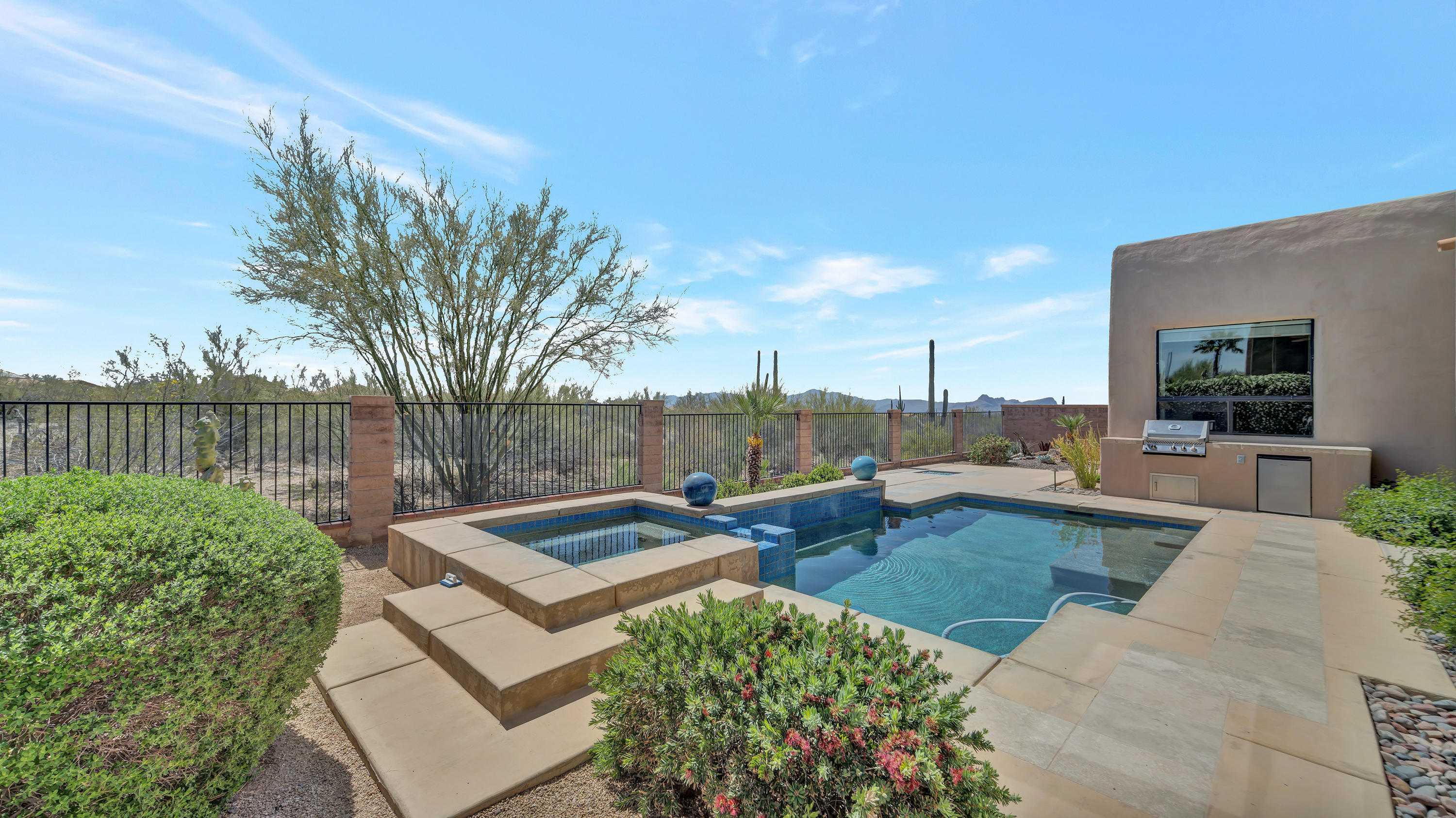 Incredible backyard Catalina views at this extended Eagle plan home by Insight Homes! Backing to lush desert w/mountain views! Gated courtyard accented by bubbling fountain & climbing roses. Large foyer opens to living/dining w/ clerestory windows above wall of windows with beam & plank ceiling. Stunning kitchen/family room featuring: staggered cabs, island, large walk in pantry, GE Monogram appl, island w/ breakfast bar, family dining, kiva FP. Expansive master suite features bay window seating, patio access, dual vanities, roomy shower, large walk in closet. BRs 2 & 3 share a Jack & Jill bath. BR 4 has access to hall bath. Den w/ doors is possible 5th BR! Laundry has sink & cabs. Your backyard desert oasis offers: pool & spa w/ waterfall, Blt in BBQ & fridge, glass fire feature.