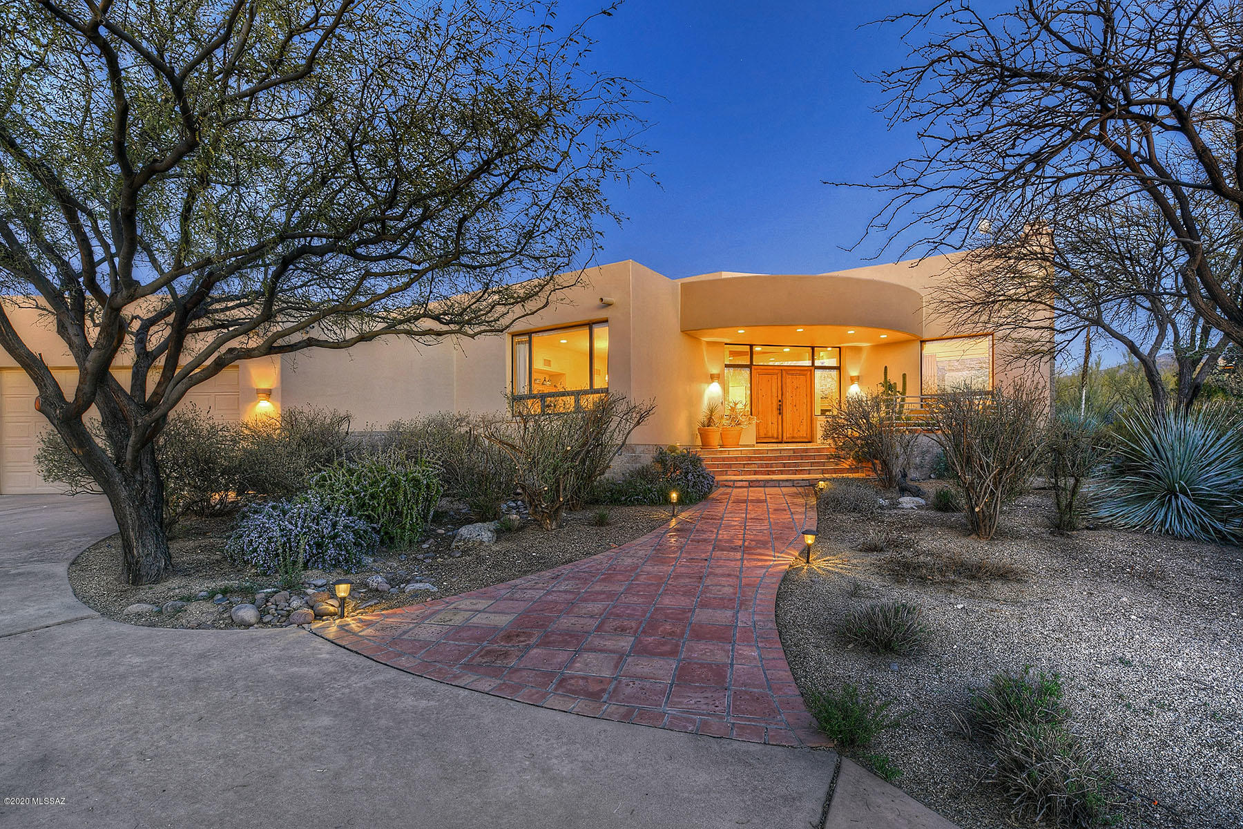 Contemporary Southwestern custom masonry home perfectly sited on fabulous 2.64 acre lot that backs to protected area & forever stunning views! Enter to discover soaring wood beamed ceilings, sold wood doors, saltillo tile floors & walls of windows to capture the desert beauty beyond. Dramatic great room is the heart center of the house & connects to the formal living & dining in a contiguous OPEN floor plan. 4 guest bedrooms incl attached guest quarters w/ en suite bath & private den that doubles as a home library, an executive home office is lined with custom alder built-ins, & the generous eat-in kitchen w/custom alder cabinets & granite counters also has bar seating & charming window-lined breakfast nook. Gated Community is host to pond, sport & tennis courts, horse facilities & more! This custom masonry home is built with extra-quality as the block is also filled for extra R-factor value & the connecting joints are made of steel.  Also check out the incredible community area that's  a 2 minute walk away!