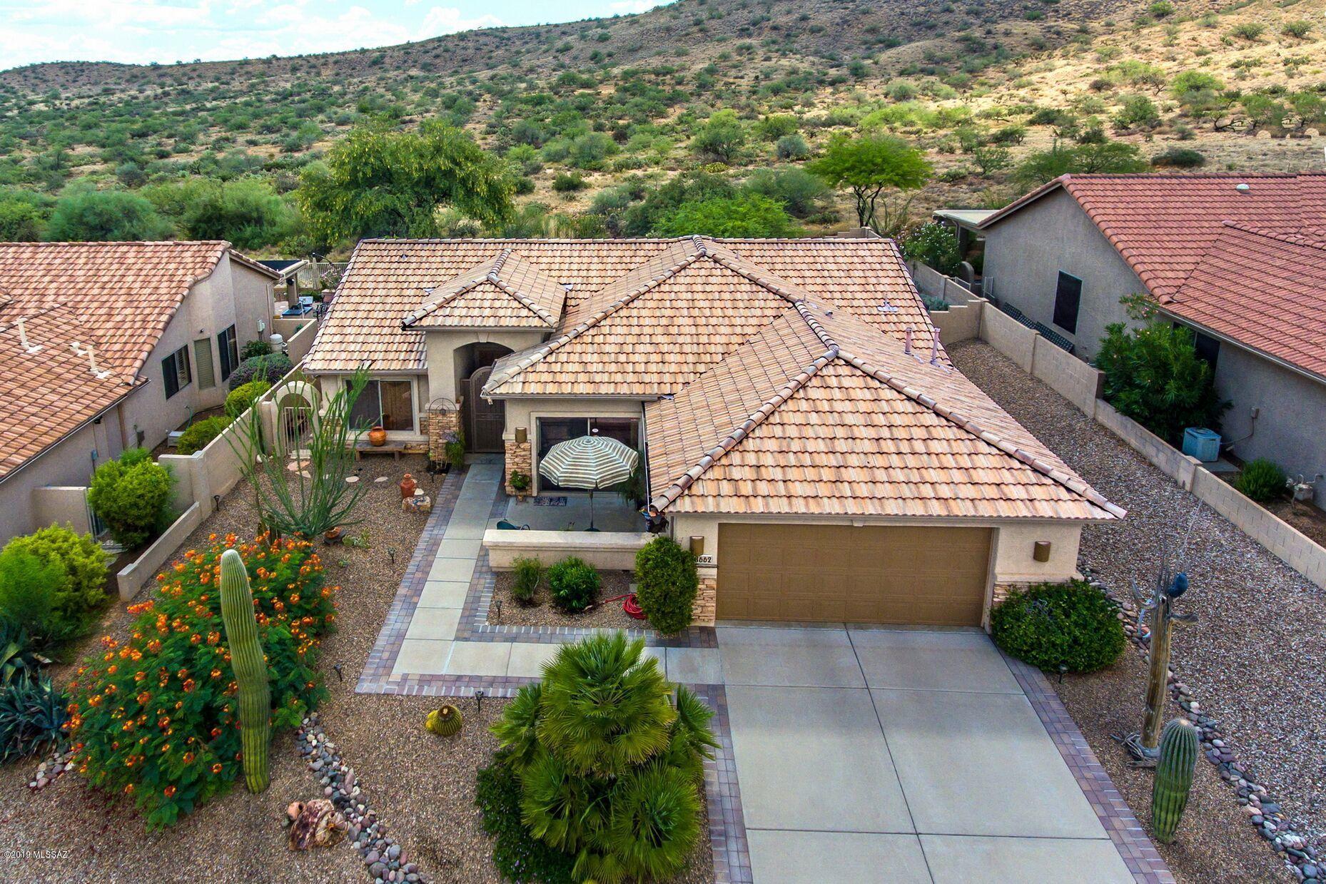 Well-maintained one-owner home in SaddleBrooke! Popular Laredo 2 bedroom/2 bath + den home boasts an open floor plan ideal for entertaining. This charming home is located on a premium lot bordering natural desert and hillsides in back yard.  Mountain views in front! Kitchen upgrades include hickory cabinets, granite counters, stainless steel appliances, gas range and under cabinet lighting. Extended length garage ideal for workspace, golf cart or scooter. Backyard features roll down shades at patio, citrus trees and desert landscaping ideal for year-round enjoyment! Short golf cart ride to restaurants, walking path, sports and dog parks. This home is must see!