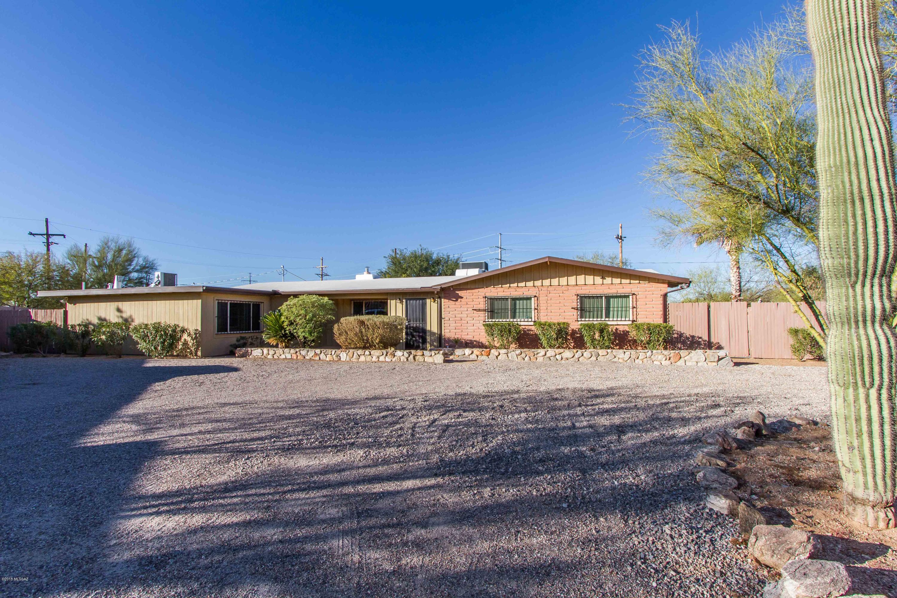 Charming and spacious adobe brick home on desirable Northwest side. 4 bedroom, 3 bathroom. 4th bedroom has separate private entrance and would be perfect for guest quarters! Living room, dining room and ''bonus room'' that could be game room, office or den! Updated kitchen and bathrooms. Newer roof, HVAC system, dual pane windows and sliders, upgraded electrical, plumbing, and so much more! Large back patio, pool-sized lot, circular driveway, shed that could be a workshop, and a separate 2 car garage. Mountain views and quiet corner location! This one is a must see!