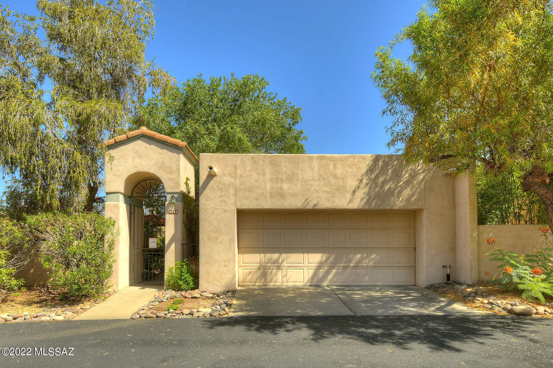 This private home is a garden paradise with mountain views, in gated Kachina Hills!  This light, bright, and airy home with 2BR/2BA and 2-car garage is stunning.  Beautiful Italian Porcelain floors throughout. 14' vaulted ceilings in the great room with large windows create a bright open floor plan and highlight scenic views of the mountains.  Double French doors open to a spacious yard and beautiful garden courtyard. Watch the sunset on the private patio.  This well-cared-for home includes an updated kitchen with granite counter tops, stainless steel appliances and a breakfast nook.  Bedrooms have updated California closets. Great location. Community pool and spa. Don't miss your chance to own this wonderful home!