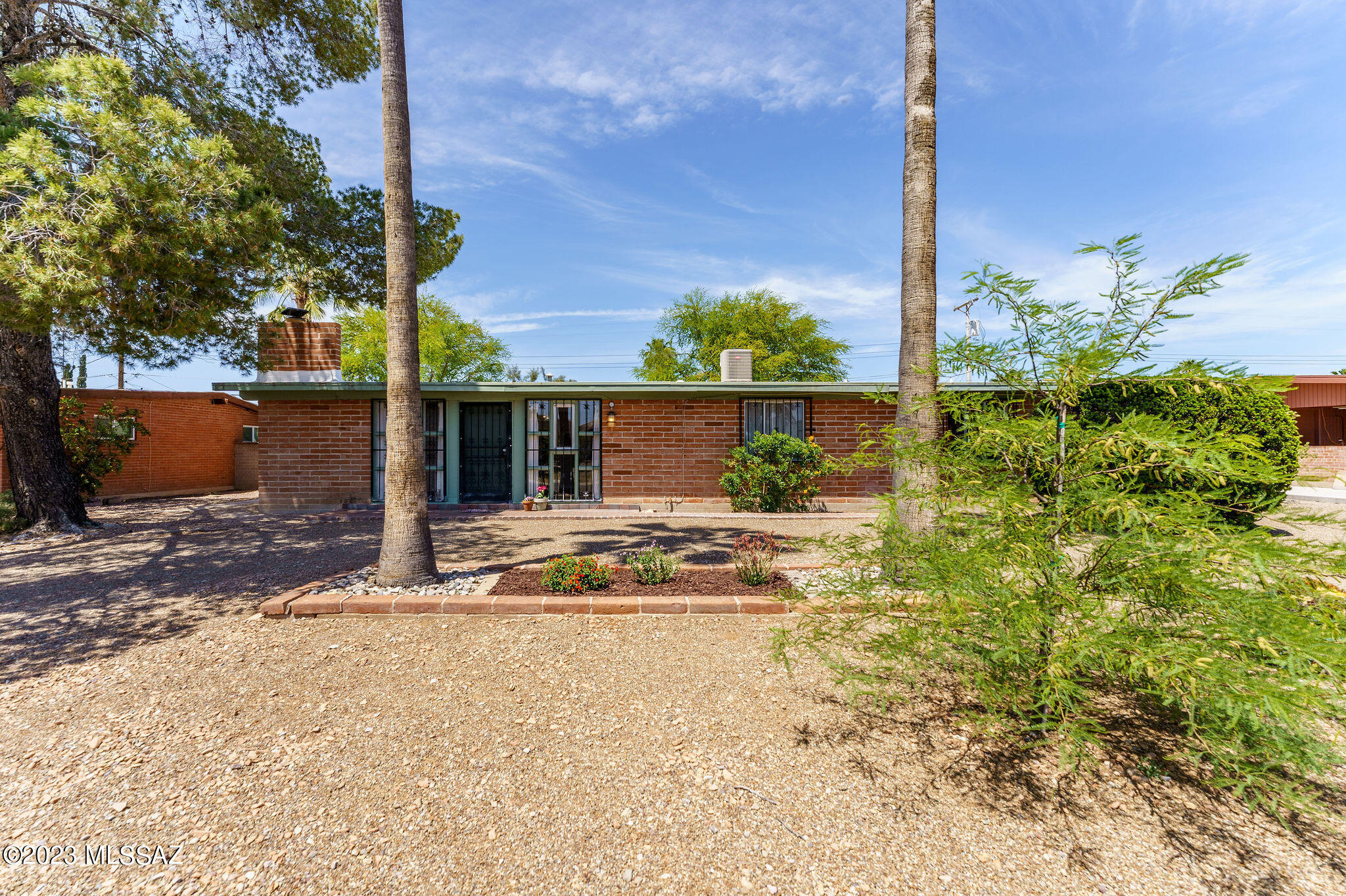 A rare opportunity in central Tucson, this 3 bedroom, 2 bathroom mid-century charmer with detached 1 bedroom, 1 bathroom guest house has been wonderfully maintained and cared for. The main house features a bright and open floor plan with tongue in groove ceilings, wood flooring throughout most of the home, kitchen with wood cabinets and island, and two living rooms, The guest house boasts a completely remodeled bathroom, full kitchen with island, separate living area and bedroom, new roof, mini split, separate fenced off backyard, and patio with a private entrance and parking. Close to restaurants, shopping, and schools, this one won't last!