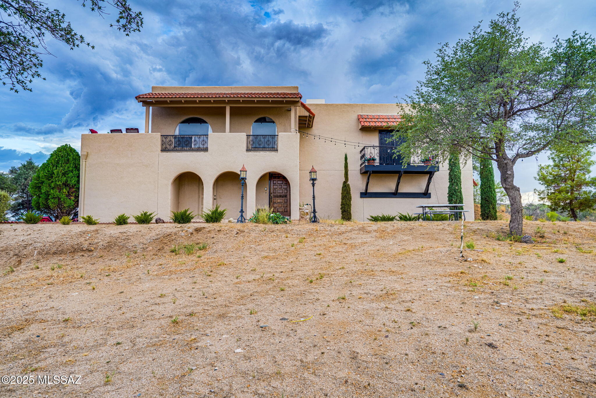 Set on 12 acres of gently rolling land with panoramic 360 views, this exceptional estate offers the perfect blend of luxury, tranquility, and western charm. From sunrise to sunset, every direction offers a breathtaking view and a sense of peace that's hard to find. This stunning two-story main residence features elegant living spaces filled with natural light and captivating scenery from every window. Soak in the views from your private balcony from master suite. Outdoors, the estate is a true equestrian paradise with a roping area, barn, and corral. A large sparkling pool serves as the centerpiece of the backyard, ideal for entertaining or unwinding under the open sky.  A spacious workshop provides room for projects, storage, and creative pursuits. A beautiful guest house offers comfort and seclusion for family or friends, complete with its own living spaces and scenic outlooks. Also a perfect retreat for Airbnb. Privately gated and surrounded by natural beauty, this remarkable property is the perfect sanctuary for those seeking space, peace, and timeless country elegance