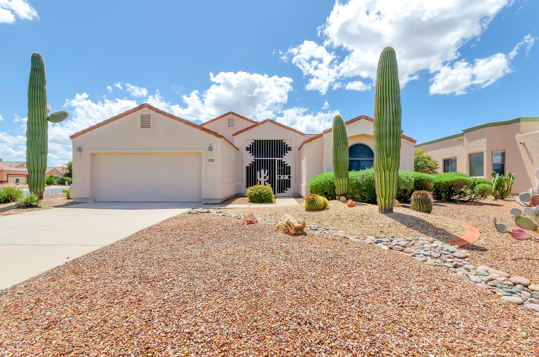 Extravagance is blended with remarkable amenities that completely redefine your quality of living! Here you have a place overflowing with unique experiences, & exceptional retirement bliss! Positioned perfectly on a corner lot, where there is more privacy, a spacious yard, a separate guest house casita for family members or a home office, a built in BBQ, trickling water feature, & a peaceful covered patio to enjoy the AZ sunsets.  Tile flooring throughout with exception of the bedrooms, a 2 sided gas fireplace adds an extra allure to the living & family room off from the kitchen. 2 bay windows, 1 in the breakfast nook & 1 in the master suite that also has a tranquility soaking tub, walk in closet, & dual vanity sinks. Interior and exterior freshly painted plus a NEW ROOF! Make this yours!