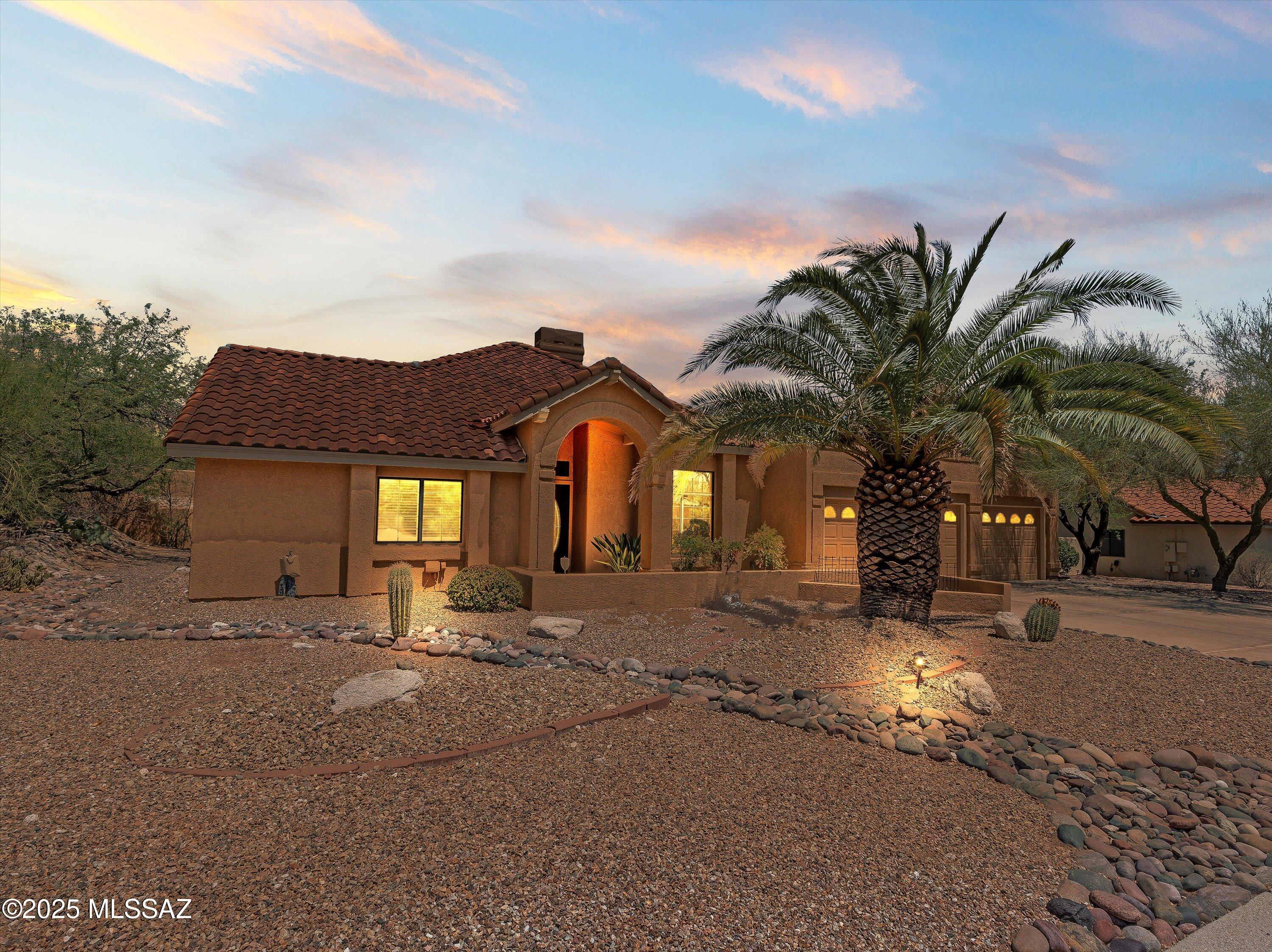 Welcome to luxury desert living in the prestigious Casas de Ventana neighborhood! This stunning 4-bedroom, 3-bathroom home at 6130 N Calle Matamoros offers 2,475 square feet of completely updated luxury on a sprawling lot of nearly half an acre with spectacular Catalina Mountain views from the east-facing backyard. Nestled in the highly sought-after Catalina Foothills School District 16 and just steps from Ventana Vista Elementary, this meticulously renovated home is a true showstopper.

The aerial view alone will take your breath away - this property showcases the perfect marriage of luxury living and natural desert beauty, with the dramatic Catalina Mountains creating a stunning backdrop. Step inside to discover a masterpiece of design and craftsmanship featuring soaring vaulted ceilings and gorgeous travertine tile flooring throughout. The heart of the home showcases a chef's dream kitchen with rich cherry cabinetry, gleaming granite countertops, and an exquisite mosaic tile backsplash. Stainless steel appliances complete this culinary paradise, while the kitchen's open design flows seamlessly into the living areas.
The sophisticated living spaces feature a show-stopping double-sided fireplace adorned with intricate mosaic tile work, creating a mesmerizing focal point between the spacious family and living rooms. The formal dining room commands attention and frames the beautiful natural light. Retreat to the luxurious master bathroom - a true spa sanctuary featuring dual granite vanity tops with ornate carved wood cabinetry, a separate glass-enclosed shower with elegant tile work, and decorative niches with built-in storage.
The unique 4th bedroom with separate entrance and full bath offers endless possibilities as guest quarters. But the real magic happens when you step outside to your private east-facing backyard paradise with breathtaking Catalina Mountain views. Wake up to stunning mountain sunrise views every morning from your own personal oasis. The sparkling curved pool with fun slide becomes the centerpiece of entertainment, complemented by a relaxing spa and multiple covered outdoor living areas perfect for hosting gatherings or quiet contemplation. Mature desert landscaping creates a lush, private setting while the property backs to a natural wash ensuring ultimate tranquility.
Additional highlights include newer zoned HVAC systems for year-round comfort and a spacious 3-car garage. The location truly sets this home apart - minutes from Whole Foods, premier dining, and shopping, while being close to prestigious Ventana Canyon, Skyline, and La Paloma Country Clubs, plus world-class hiking trails in the stunning Catalina Mountains. This is sophisticated desert living at its absolute finest!