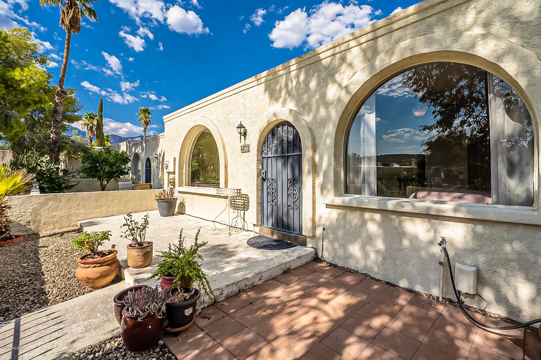 Welcome to Hidden Valley! This beautifully remodeled 3 bed 2 bath vintage town-home, combines classic retro architecture with the functional amenities we all want today. The one level, split bedroom floor plan features 2 large bedrooms with en-suite baths, plus an additional bedroom / office just off the dining room. The kitchen features polished granite counter tops w/ glass back-splash, stainless appliances and breakfast bar. Perfect for light meals or entertaining friends. Ceramic tile flooring throughout. Community pool/spa, and clubhouse offer close-to-home relief from the desert heat. Walk or bike the trail to Sabino Canyon, enjoy a slice with friends at the Arizona Pizza Co., or take in some live music at Three Canyons pub. Low H.O.A. dues include trash pick up. District 16 schools.